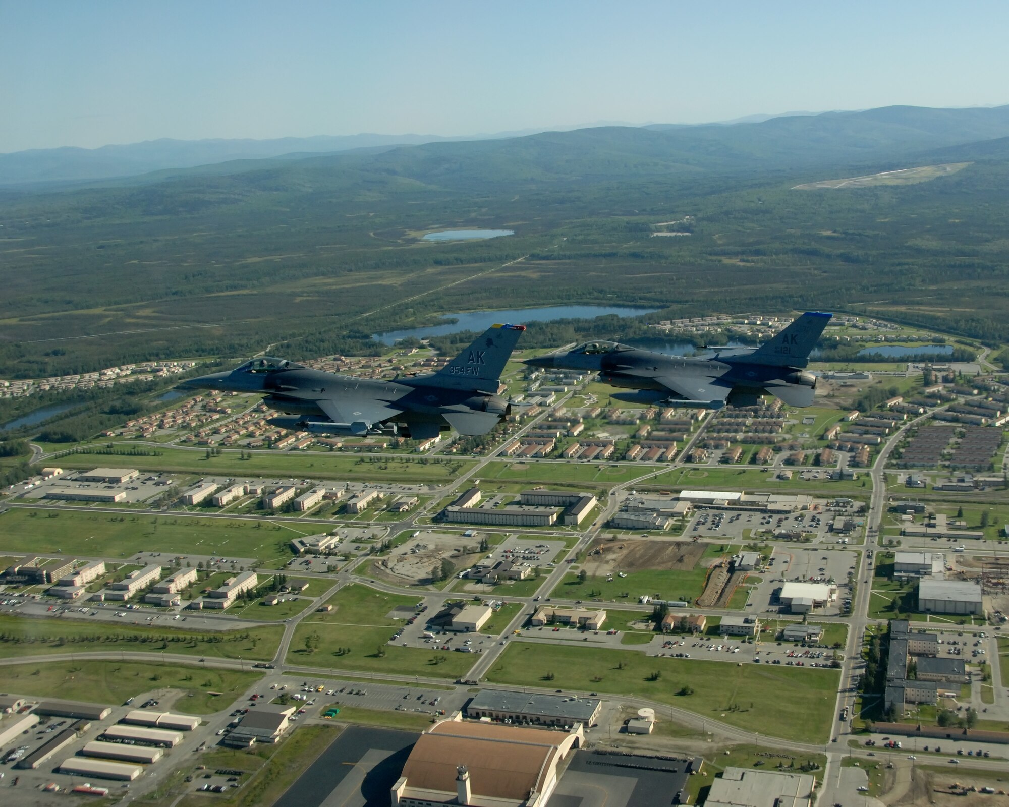 EIELSON AIR FORCE BASE, Alaska -- Brig. Gen. David Scott, 354th Fighter Wing Commander, flies formation in a F-16 Fighting Falcon aircraft over Eielson Air Force Base during his fini flight on Aug. 17. General Scott arrived at Eielson AFB back in Dec. 05 and will be departing in Aug. 07 to a North Atlantic Treaty Organization base in Greece as the Deputy Commander of Combined Air Operations Center. (U.S. Air Force Photo by Master Sgt Rob Wieland)