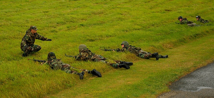 Senior Airman Neal Clark, 100th Civil Engineer Squadron Readiness and Emergency Management, keeps lookout for "enemies" during a short-halt convoy operation Aug. 14. Eighty three 100th CES troops participated in training over a four-day period. (U.S. Air Force photo by Karen Abeyasekere)