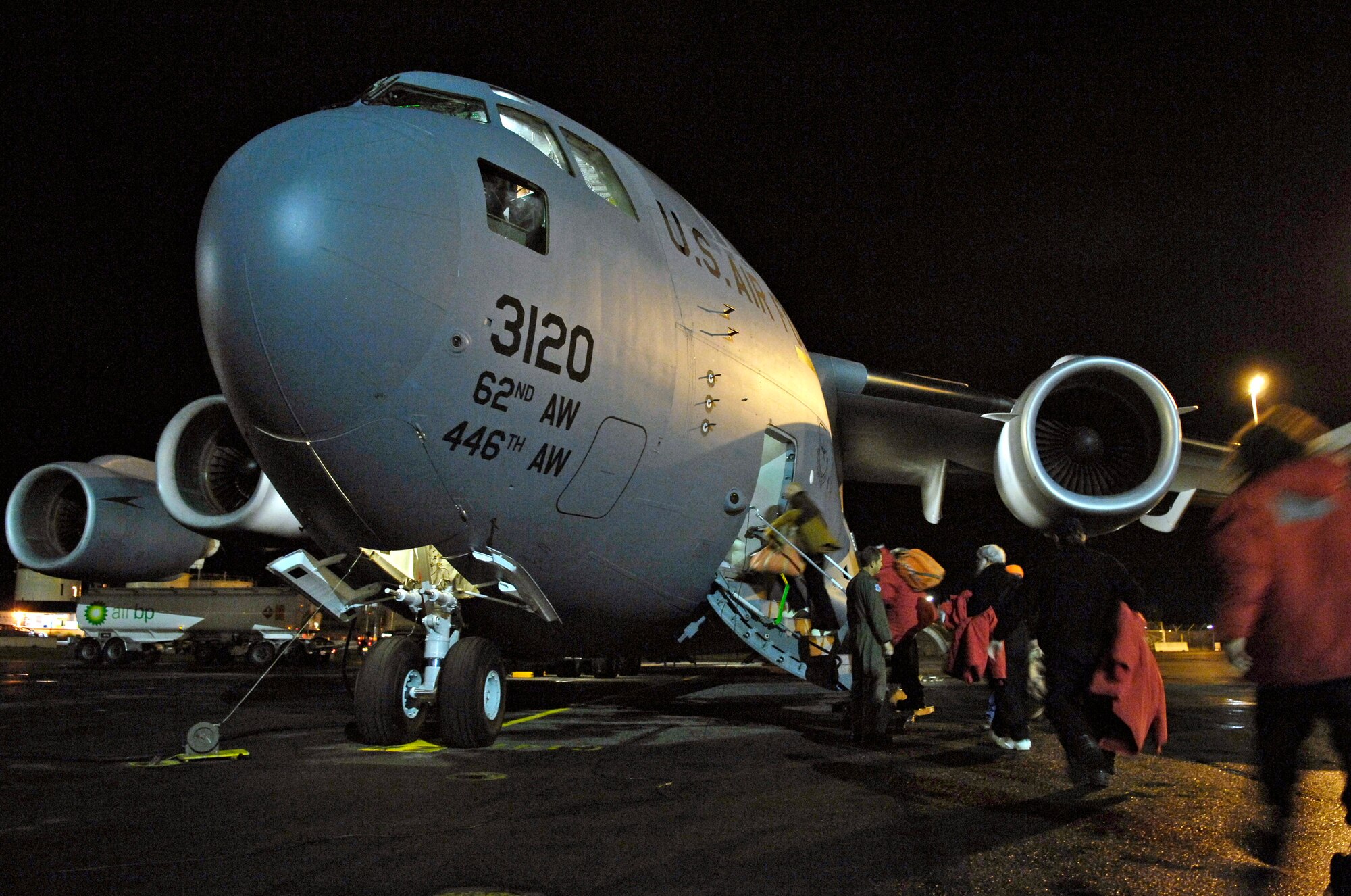 Members of the National Science Foundation load on to a C-17 Globemaster III for a winter fly-in mission for Operation Deep Freeze Aug. 20 at Christchurch, New Zealand. A C-17 Globemaster III and 31 Airmen from McChord Air Force Base, Wash., are flying in an augmentation of scientists, support staff, food and equipment for the U.S. Antarctic Program at McMurdo Station. (U.S. Air Force photo/Tech. Sgt. Shane A. Cuomo) 
