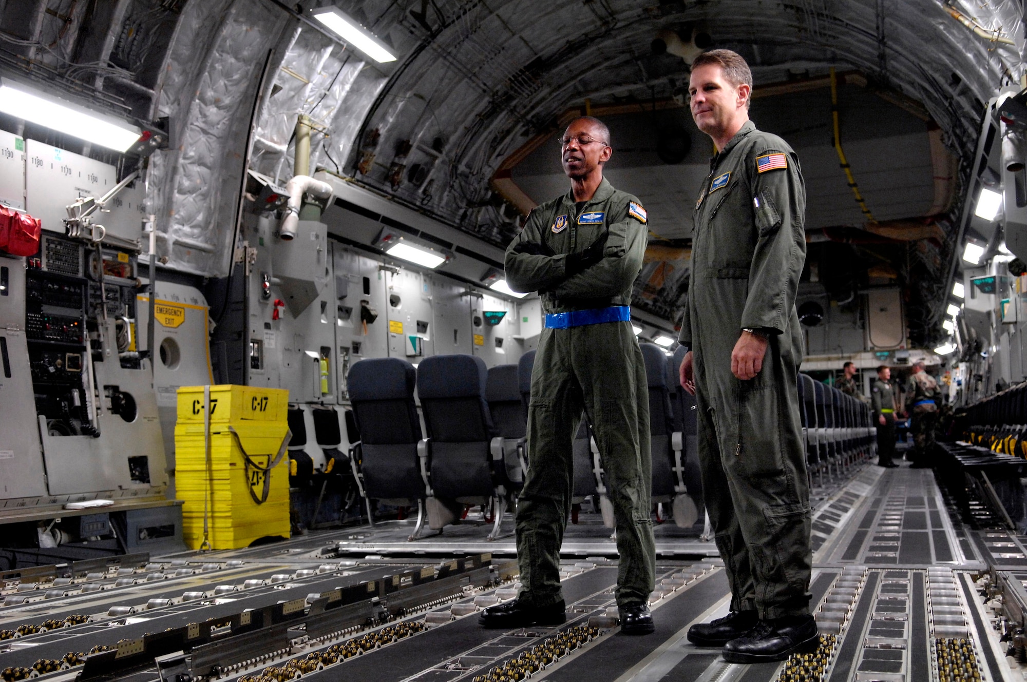 Senior Master Sgt. Terry Philon and Senior Master Sgt. Jim Masura watch as pallets are loaded onto a C-17 Globemaster III before taking off on a winter fly-in mission for Operation Deep Freeze Aug. 20 at Christchurch, New Zealand. A C-17 and 31 Airmen from McChord Air Force Base, Wash., are flying in an augmentation of scientists, support staff, food and equipment for the U.S. Antarctic Program at McMurdo Station. (U.S. Air Force photo/Tech. Sgt. Shane A. Cuomo) 
