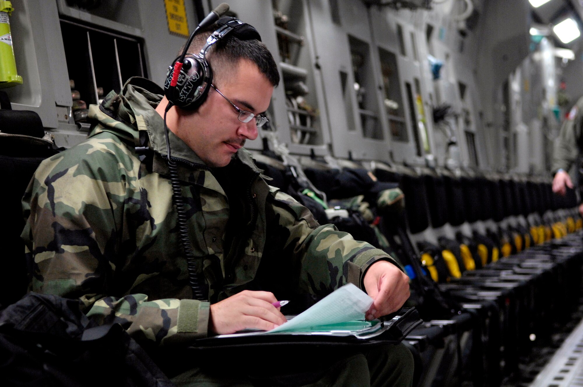 Staff Sgt. Christopher Woods looks over a maintenance log before launching a C-17 Globemaster III for a winter fly-in mission for Operation Deep Freeze Aug. 20 from Christchurch, New Zealand. A C-17 and 31 Airmen from McChord Air Force Base, Wash., are flying in an augmentation of scientists, support staff, food and equipment for the U.S. Antarctic Program at McMurdo Station. (U.S. Air Force photo/Tech. Sgt. Shane A. Cuomo) 
