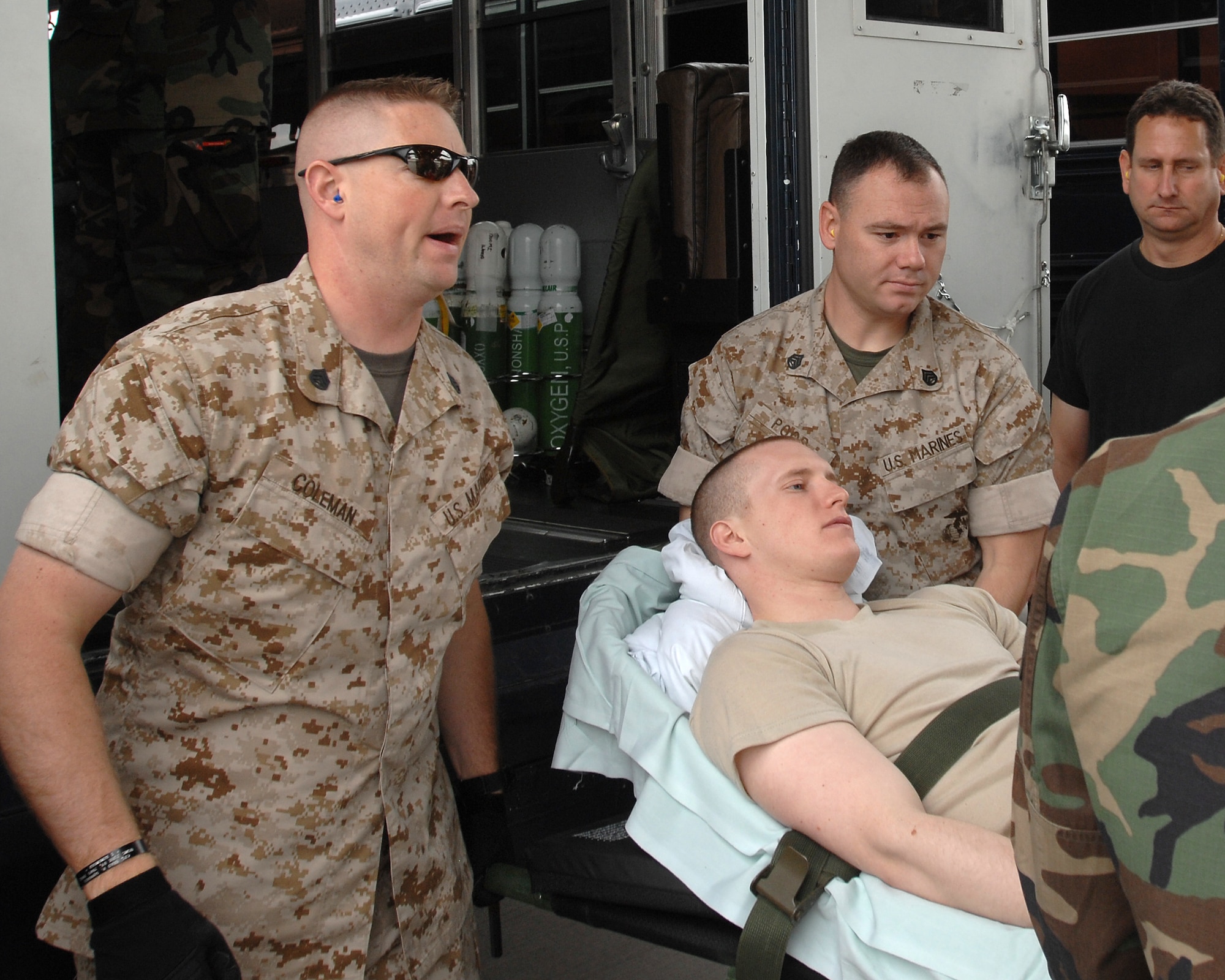 Marine staff sergeants Ben Colman (left) and Robert Poor do their part in helping load an areomedical evacuation flight August 21, 2007 at Ramstein Air Base Germany. (U.S. Air Force photo/Airman 1st Class Kenny Holston)