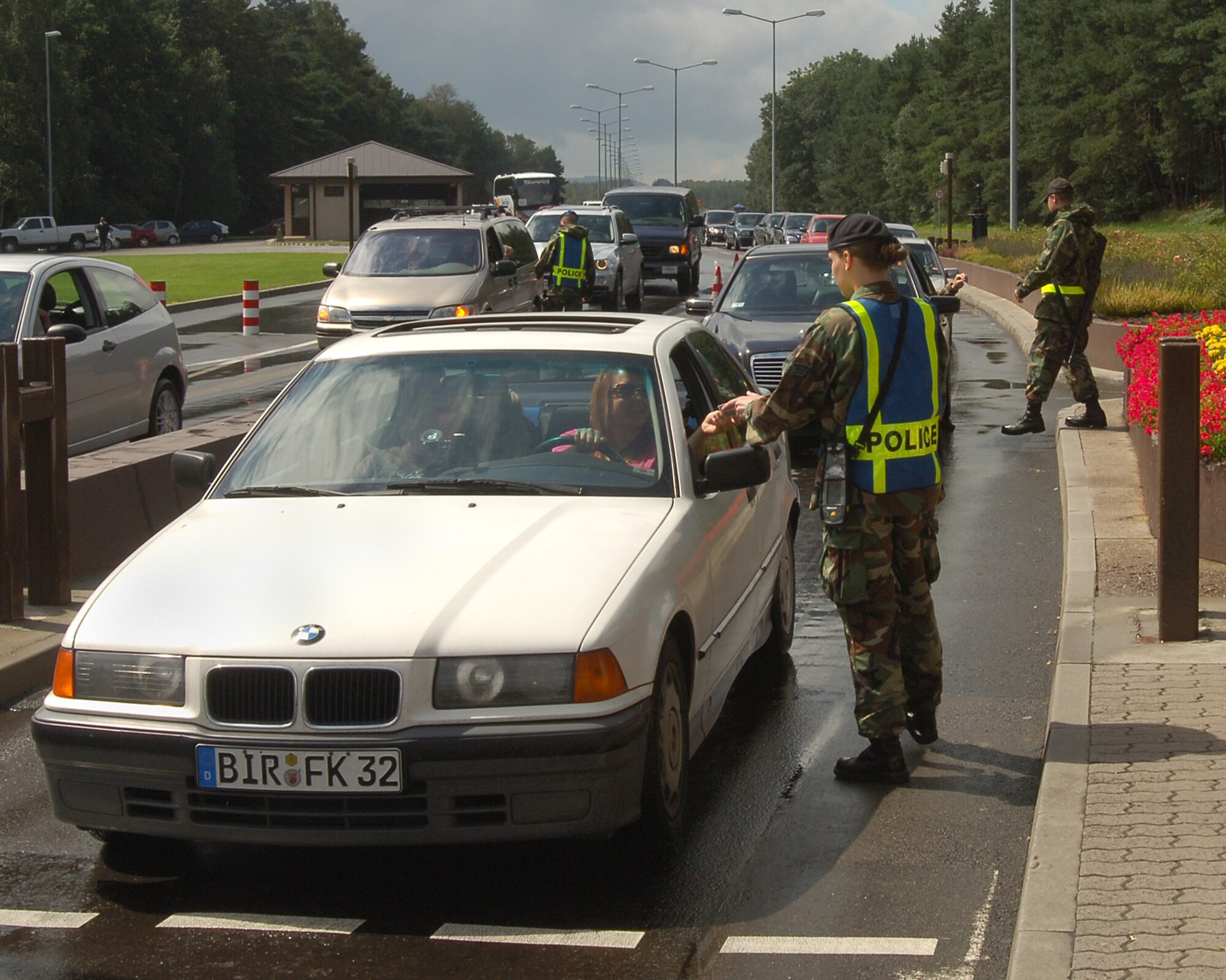 Senior Airman Kristian Wheller, 435th Security Forces Squadron, checks identification cards at Ramstein's west gate during lunch hour rush August 16, 2007 at Ramstein Air Base, Germany. Ramstein has recently upped it security measures by adding new surveillance cameras at each gate. (U.S. Air Force photo/Airman 1st Class Kenny Holston)