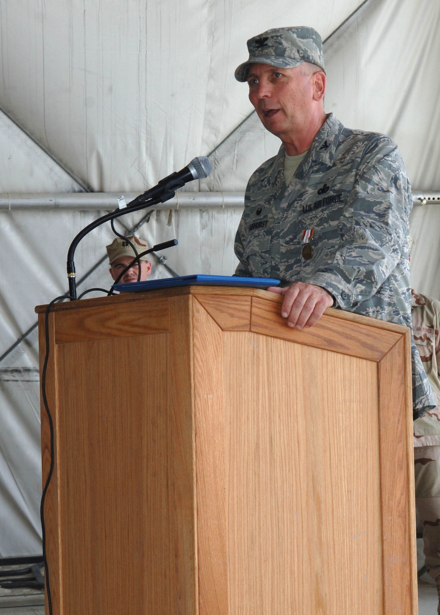 Col. Fred Fairhurst, former 755th Air Expeditionary Group commander, gives his final speech to the group as its commander during a change of command ceremony August 21 at Bagram Airfield, Afghanistan. Col. Fairhurst praised the group's Airmen for upholding their "unique chain of command." (U.S. Air Force photo by Staff Sgt. Craig Seals)