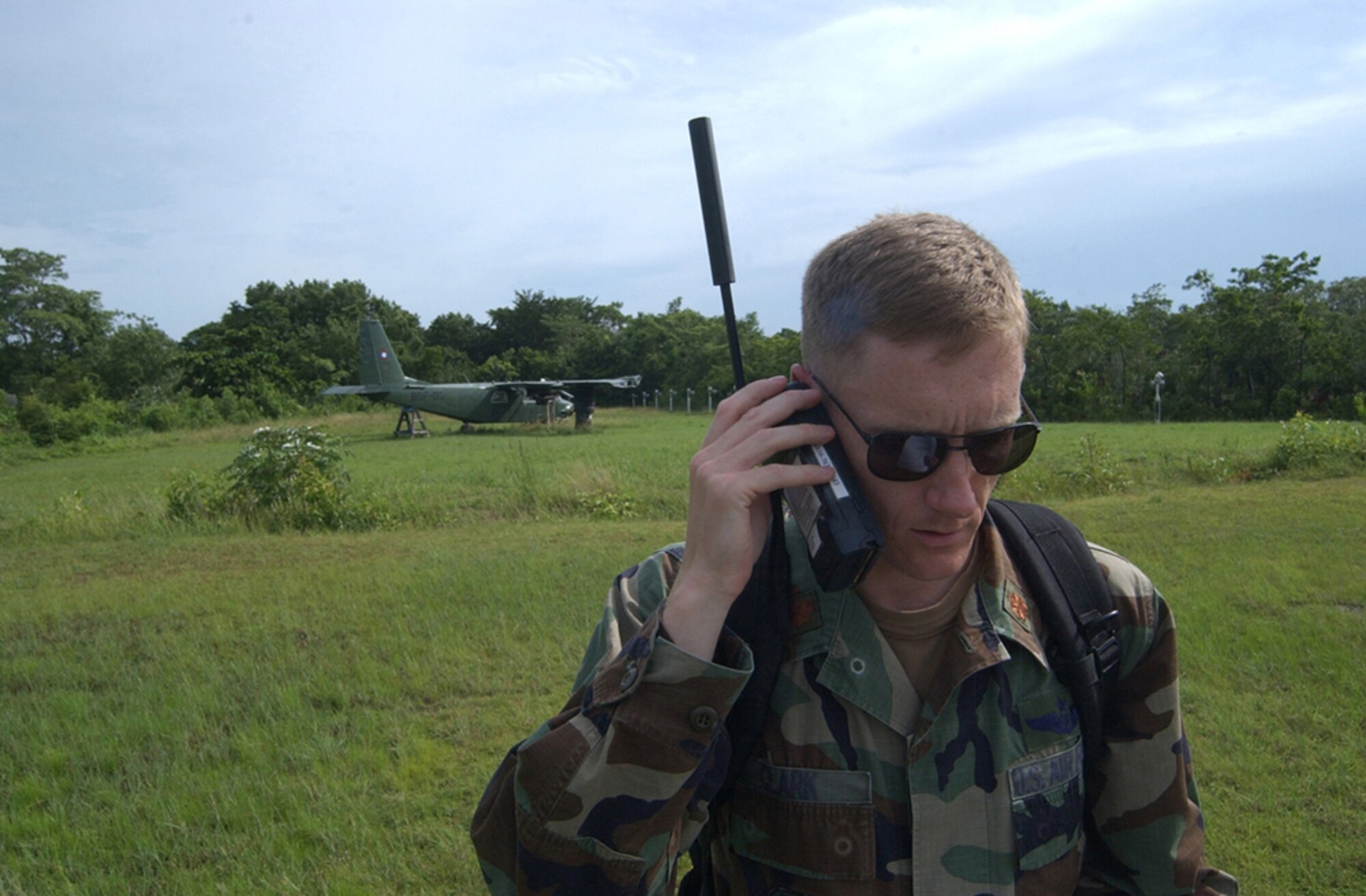 BELIZE CITY, Belize - Air Force Maj. Jason Clark, operations officer for the Tactical Operations Center here, uses a satellite phone to contact Joint Task Force-Bravo headquarters at Soto Cano Air Base, Honduras, shortly after touching down here.  Approximately 20 Soldiers and Airman from Soto Cano Air Base, Honduras, deployed here as part of an initial assessment team following Hurricane Dean Aug 21.   (U.S. Air Force photo by Tech. Sgt. Sonny Cohrs)                               