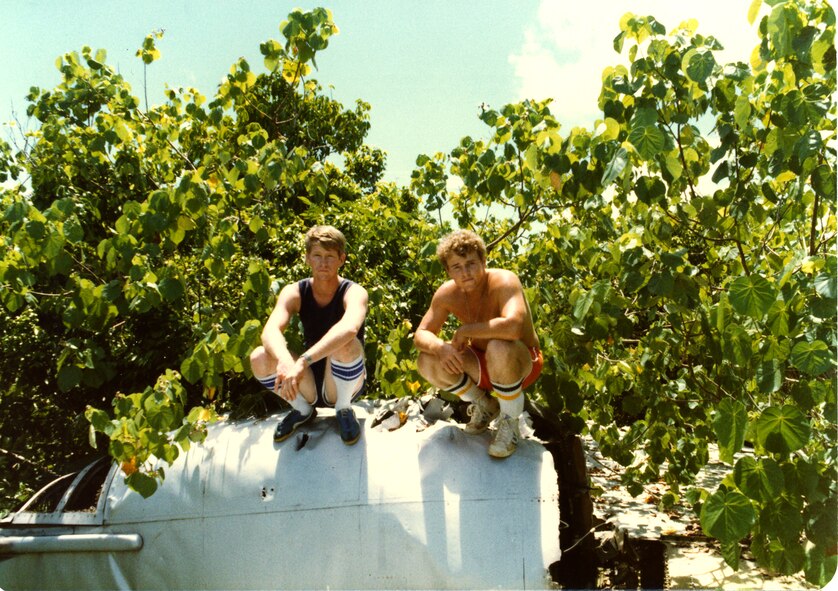 ANDERSEN AIR FORCE BASE, Guam - Chief Master Sgt. Joseph McKenney, from the 36th Munitions Squadron, took this photo of Paul Downs and James Foster, two friends who were stationed with him during his first assignment to Andersen, standing on the tail section of a B-52 in the jungle around the base. Chief McKenney was assigned to Andersen from January 1981 to April 1982.  
