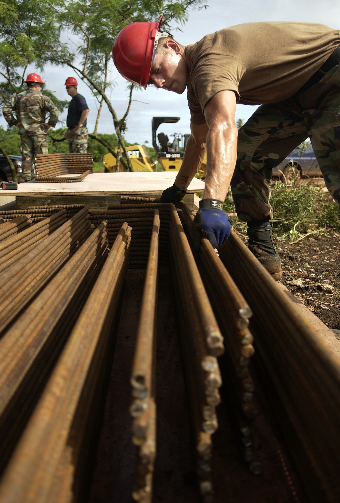 ANDERSEN AIR FORCE BASE, Guam - Airman 1st Class Christopher David, 554th RED HORSE Squadron, stacks pieces of rebar at Northwest Field, Aug. 22, 2007.  The 554th RED HORSE Squadron is currently building new infastructure on Northwest Field. (U.S. Air Force photo by Senior Airman Miranda Moorer/36th Wing Public Affairs) 