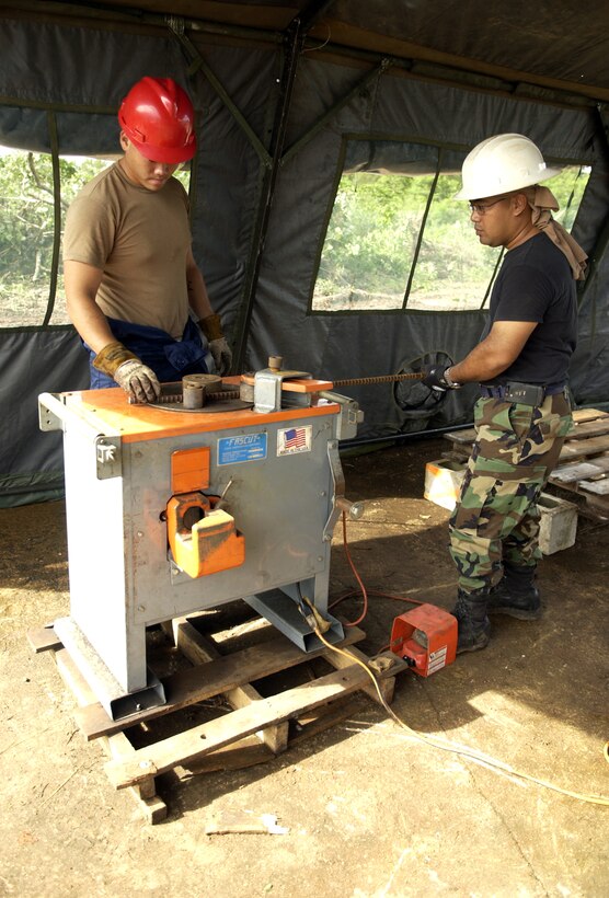 ANDERSEN AIR FORCE BASE, Guam - Senior Airman Thomas Agee and Tech. Sgt. John Sablan, both from the 554th RED HORSE Squadron, bend a piece of rebar at Northwest Field, Aug. 22, 2007.  (Photo by Senior Airman Miranda Moorer/36th Wing Public Affairs)                
