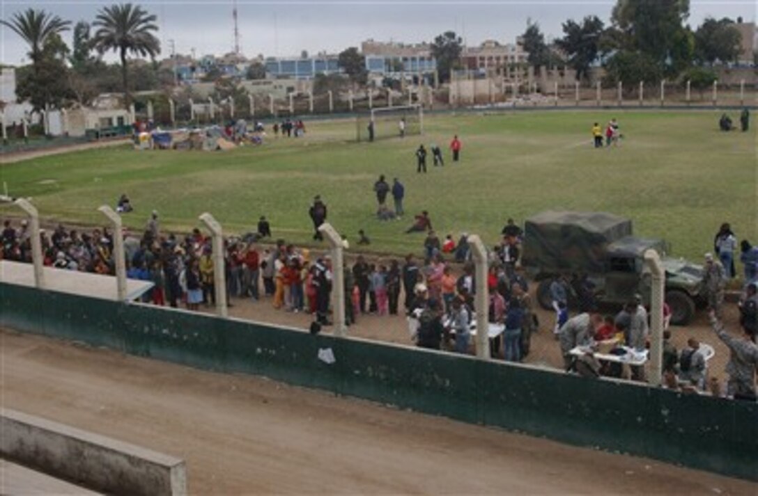 Crowds of people line up to receive medical care from members of Joint Task Force Bravo, from Soto Cano Air Base, Honduras, who deployed to Pisco, Peru. The task force is providing medical humanitarian care to people affected by the magnitude 8 earthquake that struck the region, Aug. 15.