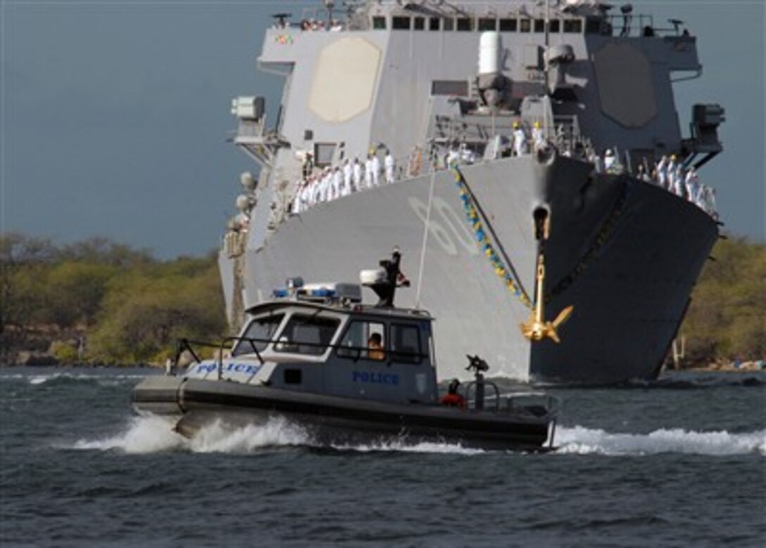 A harbor patrol boat leads the way for the guided-missile destroyer USS Paul Hamilton (DDG 60) as the ship returns to its homeport of Naval Station Pearl Harbor, Hawaii, on Aug. 20, 2007.  The Hamilton and the USS O'Kane (DDG 77) returned to Pearl after a seven-month deployment.  