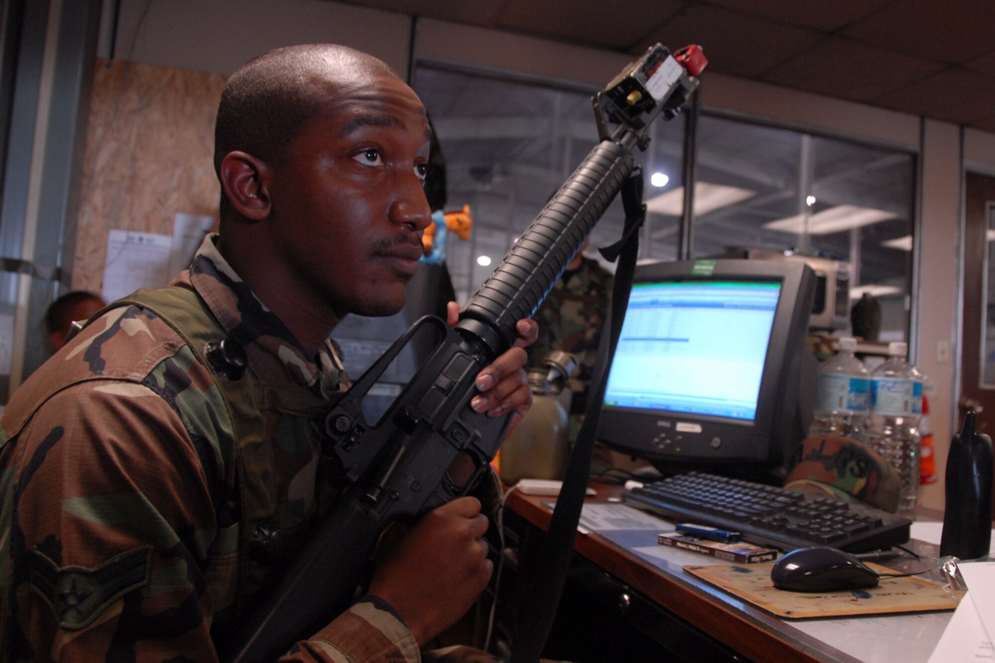 OSAN AIR BASE, Republic of Korea -- Airman First Class David Leige of the 51st Logistics Readiness Squadron, Selective Arming Team prepares for a simulated attack with the 51st Communication Squadron on August 24. SELARM scenarios test Team Osan's ability to defend the base and conduct daily operations in a combat environment. (U.S. Air Force photo by Airman 1st Class Chad Strohmeyer) (Released)