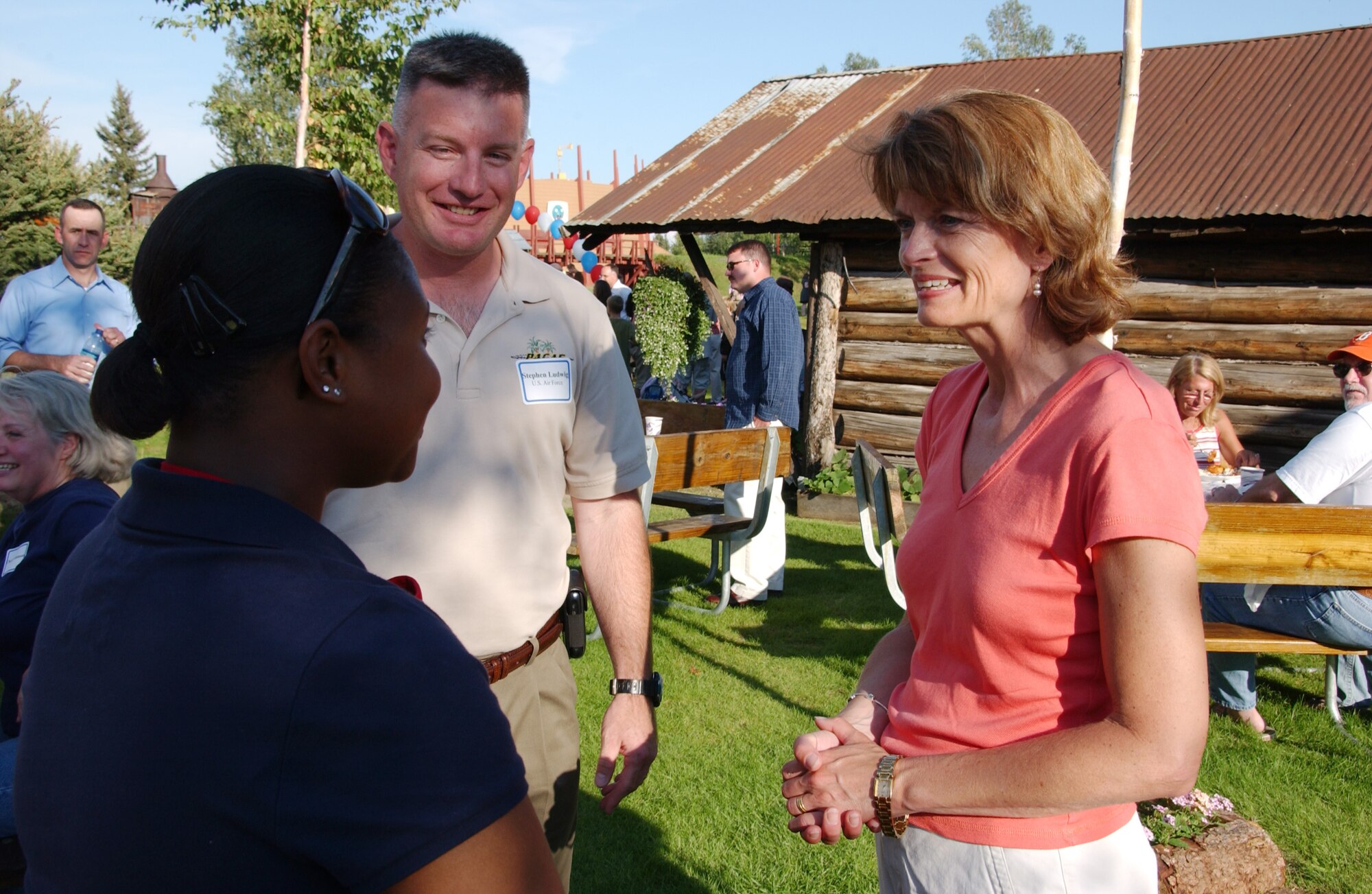 EIELSON AIR FORCE BASE, Alaska -- Chief Master Sgt. Stephen Ludwig (middle), 354th Fighter Wing command chief, introduces Airman 1st Class Kristian Atkinson (left), 354th Medical Group, to Senator Lisa Murkowski (Right) of Alaska during the Red, White and Blue Garden Party Aug. 18. Pioneer Park held its annual Military Appreciation Day with free food, activities, and live bands throughout the day. (U.S. Air Force Photo by Airman 1st Class Jonathan Snyder)(Released)