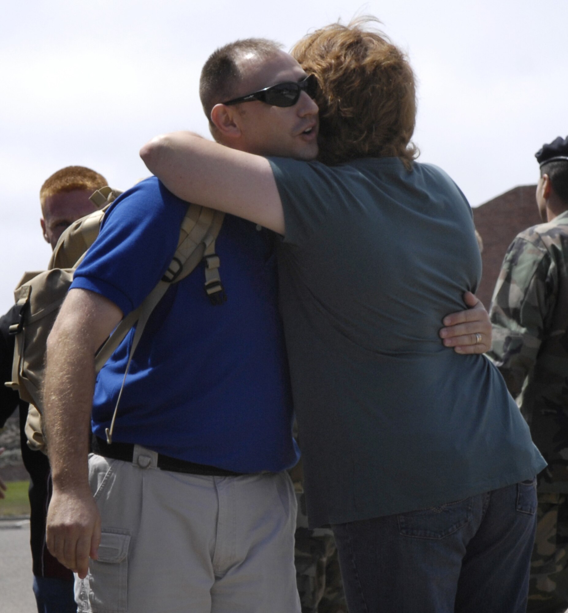 VANDENBERG AIR FORCE BASE, Calif. -- Tech. Sgt. Michael Fries, 30th Security Forces Squadron, hugs his wife, Debra, as he returns home from a deployment on Aug. 22. The 25 Airman, who compose 2 teams, returned from a six-month deployment at Al Udied, Qatar.  (U.S. Air Force photo/Airman Jonathan Olds)