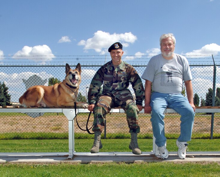 FAIRCHILD AIR FORCE BASE, Wash. -- After a day of touring the military working dog facilities here and putting Tico, a military working dog, through some paces on the obstacle course, Tech. Sgt. Max Talley, 92nd Security Forces Squadron kennel staff, Mr. David Adams and Tico take a break on the dog walk. Mr. Adams, a former dog handler with the 92nd Bomb Wing, was visiting Fairchild nearly 30 after he was stationed here. (U.S. Air Force photo / Airman 1st Class Josh Chapman)