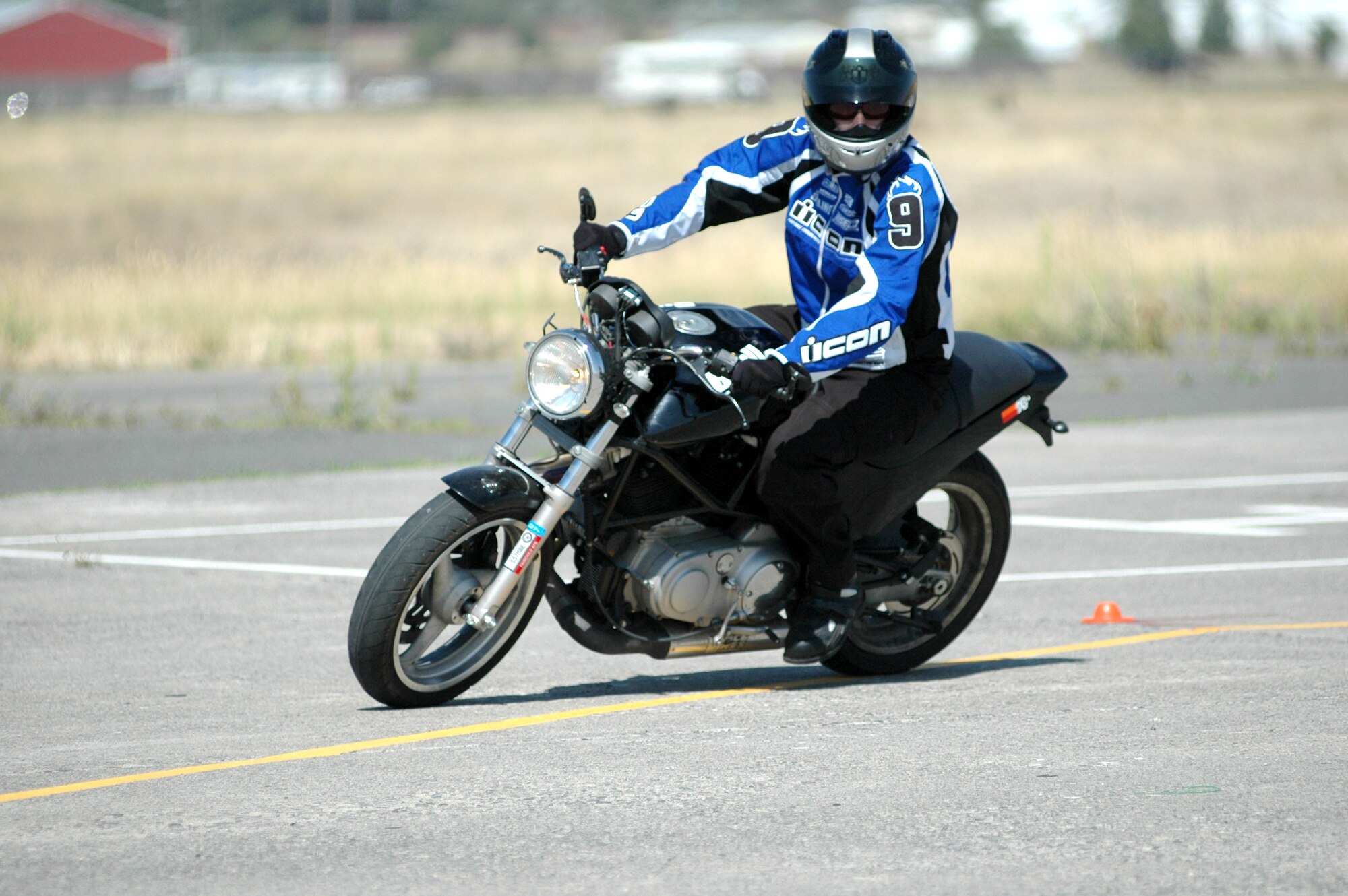 FAIRCHILD AIR FORCE BASE, Wash. – Senior Airman James Harris, 92nd Operations Support Squadron intelligence, leans into a turn during the multiple corner drill during the U.S. Air Force Sport Bike Training class here Aug. 16. The class is a vital part of motorcycle safety due to the fact that a majority of automotive casualties in the Air Force come from sport bike accidents. The annual class will become mandatory for all sport bike riders next year. (U.S. Air Force photo / Tech. Sgt. Larry W. Carpenter Jr.)