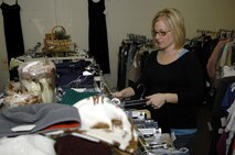 MINOT AIR FORCE BASE, N.D. -- Maria McKenna helps get the base thrift store ready before it reopened its doors Aug. 23. The thrift shop is open from 9:30 a.m. to 2:30 p.m. Tuesdays and Thursdays and consignments are taken from 9:30 a.m. to 11:30 a.m. Tuesdays and Thursdays. For more information, call 727-6618. (U.S. Air Force photo by Senior Airman Christopher Boitz)