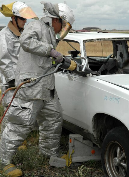 FAIRCHILD AIR FORCE BASE, Wash. – Using a Hurst cutter, a tool used when the “Jaws of Life” are needed, Airman 1st Class Alex Parrish, 92nd Civil Engineer Squadron fire protection flight driver operator, cuts through bits of a motor vehicle during training Aug. 20. This is one of the many training exercises the flight performs to maintain the skills needed to respond to a variety of incidents. (U.S. Air Force photo / Airman 1st Class Kali L. Gradishar)