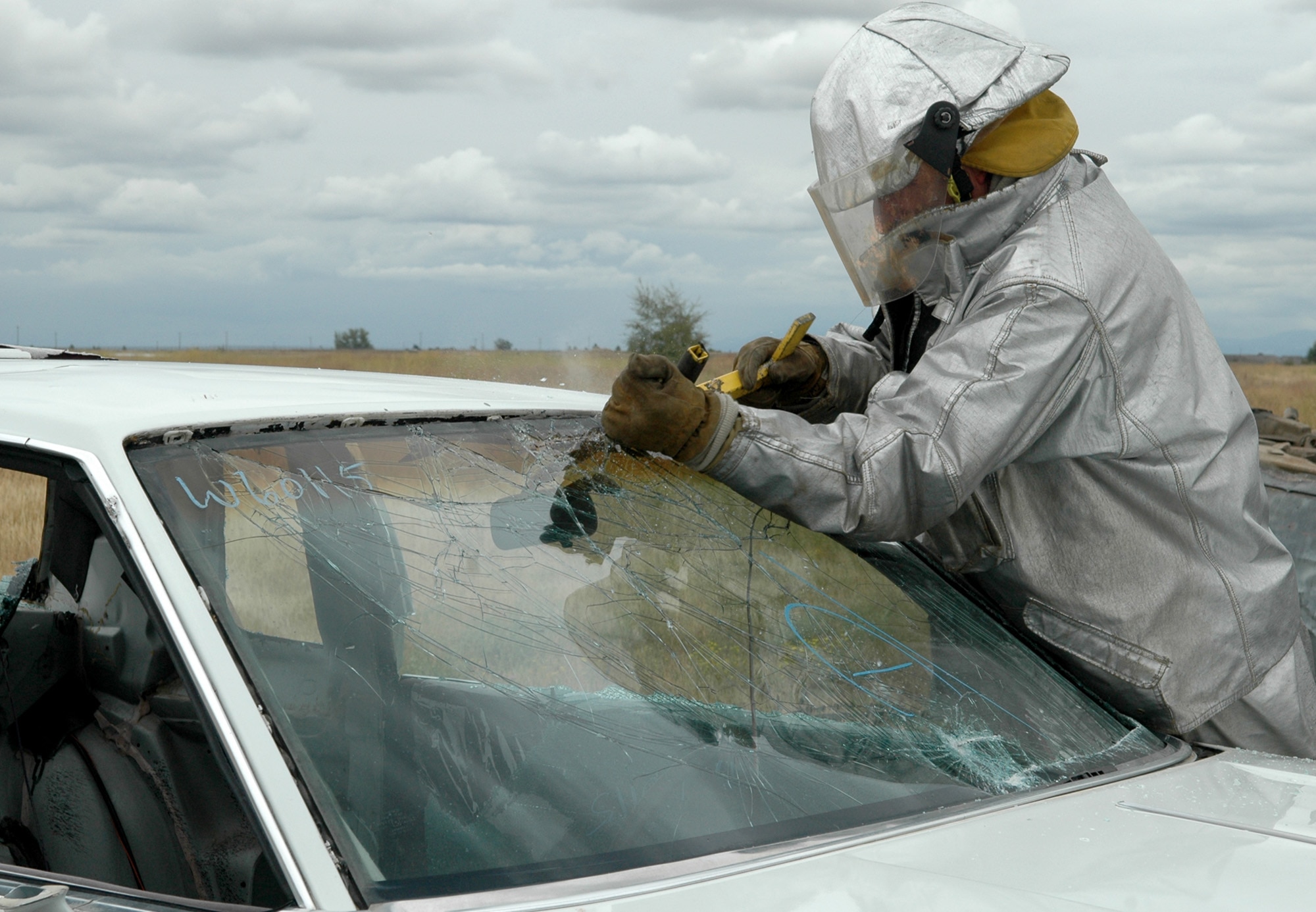 FAIRCHILD AIR FORCE BASE, Wash. – Thomas Morton, a 92nd Civil Engineer Squadron fire protection flight crew chief, uses a glass master tool to cut out the windshield of car during training Aug. 20. The flight used training vehicles to practice the extrication of a victim in a motor vehicle accident. (U.S. Air Force photo / Airman 1st Class Kali L. Gradishar)
