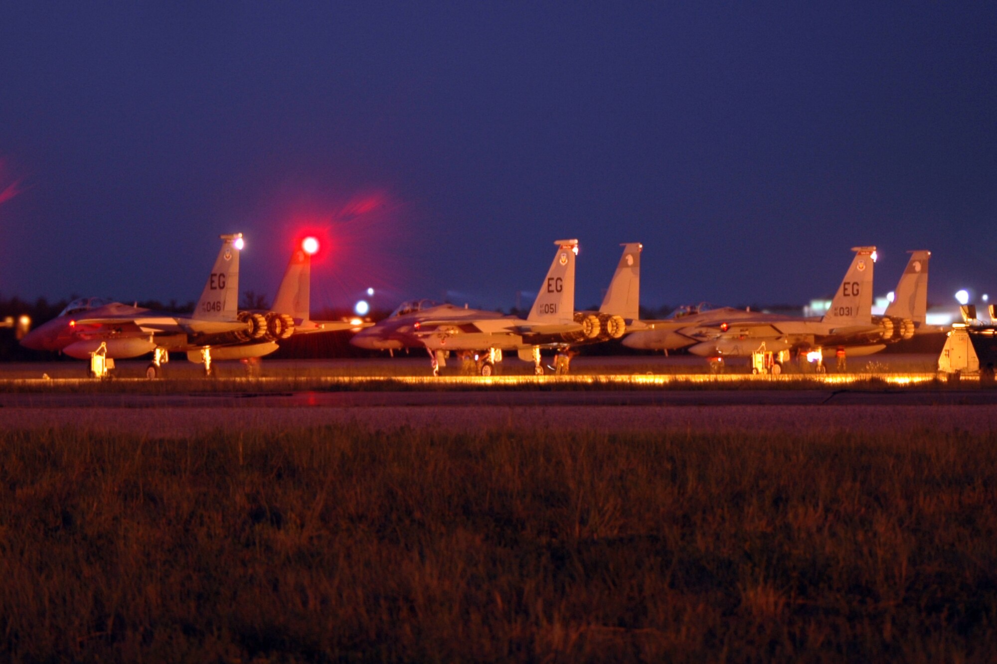 EGLIN AIR FORCE BASE, Fla. -- Three 60th Fighter Squadron F-15C Eagles with the 33d Fighter Wing at Eglin AFB, Fla. are going through their final checks before take off during night flying operations Aug. 21. Night flying is a critical element in F-15 pilot training and required on a consistent basis for mission readiness. (U.S. Photo by Staff Sgt. Bryan Franks)
