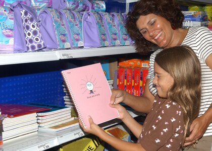 While shopping for school supplies at the Lackland Air Force Base main base exchange Aug. 20, Sarah Berry, 8, and her mother, retired Senior Master Sgt. Reda Berry, get a laugh from the "Boys are Smelly" notebook. The Lackland ISD schools open their doors for the 2007-08 school year Aug. 27. (USAF photo by Alan Boedeker)
                               