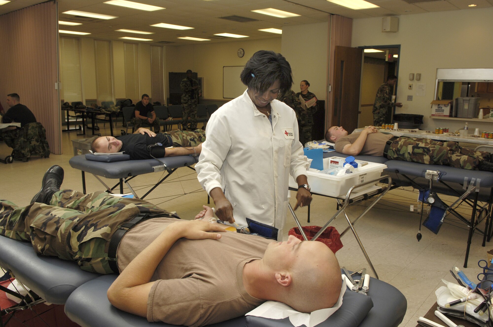 Red Cross Donor Collector Jakara Siler prepares Airman 1st Class Josh Kohut, 305th Civil Engineer Squadron engineering apprentice, to donate blood. McGuire members donated 55 pints to the blood drive, which took place Aug. 22 at Chapel 1 here. (U.S. Air Force photo by Kenn Mann)