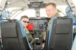 Joshua Wooten sits in the cockpit of a T-1 with Lt. Col. Dave Green (right) of the 12th Operations Support Squadron. (Photos by Don Lindsey)