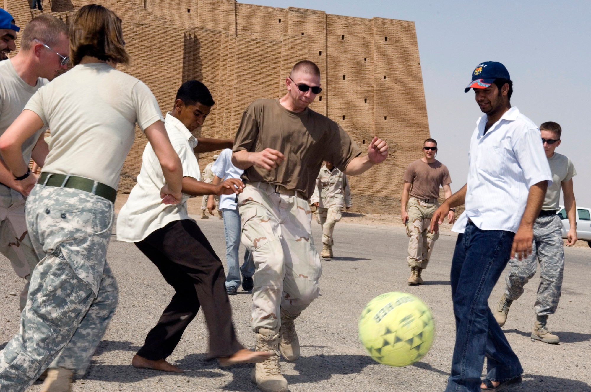 Airmen, Soldiers and local Iraqi citizens play soccer during an Aug. 21 visit by 80 Iraqi citizens to the historical Ziggurat located on Ali Air Base, Iraq. The Ali AB First Four Council sponsored the visit. This is the first time in more than 10 years that Iraqi civilians have been allowed to step on the grounds of the historical site, which was built in the ancient city of Ur and includes the house of the biblical prophet Abraham (U.S. Air Force photo/Master Sgt. Robert W. Valenca) 
