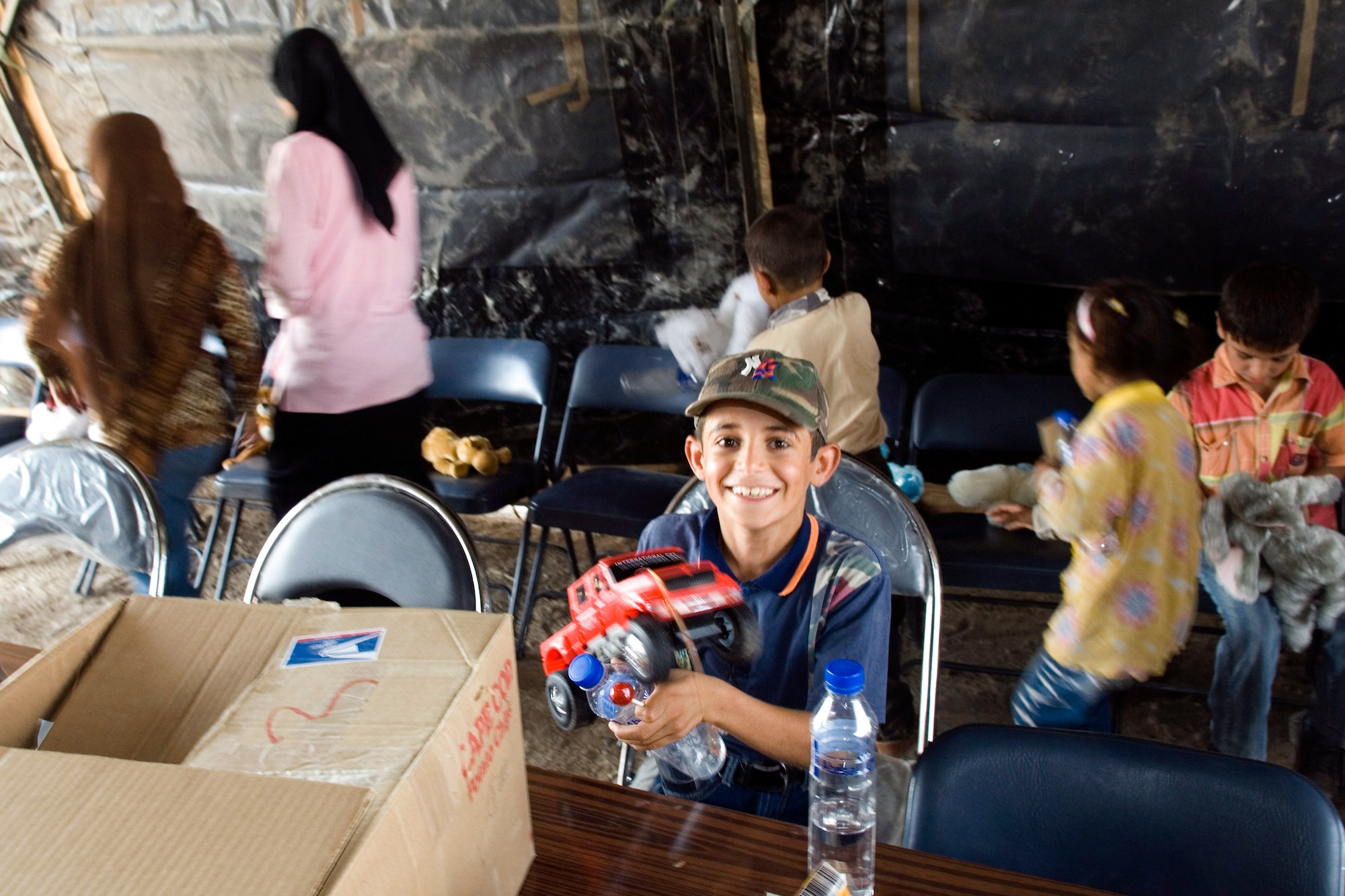 A young Iraqi boy shows off his new truck during an Aug. 21 visit by 80 Iraqi citizens to the historical Ziggurat located on Ali Air Base, Iraq. The Ali AB First Four Council sponsored the visit. This is the first time in more than 10 years that Iraqi civilians have been allowed to step on the grounds of the historical site, which was built in the ancient city of Ur and includes the house of the biblical prophet Abraham. (U.S. Air Force photo/Master Sgt. Robert W. Valenca) 
