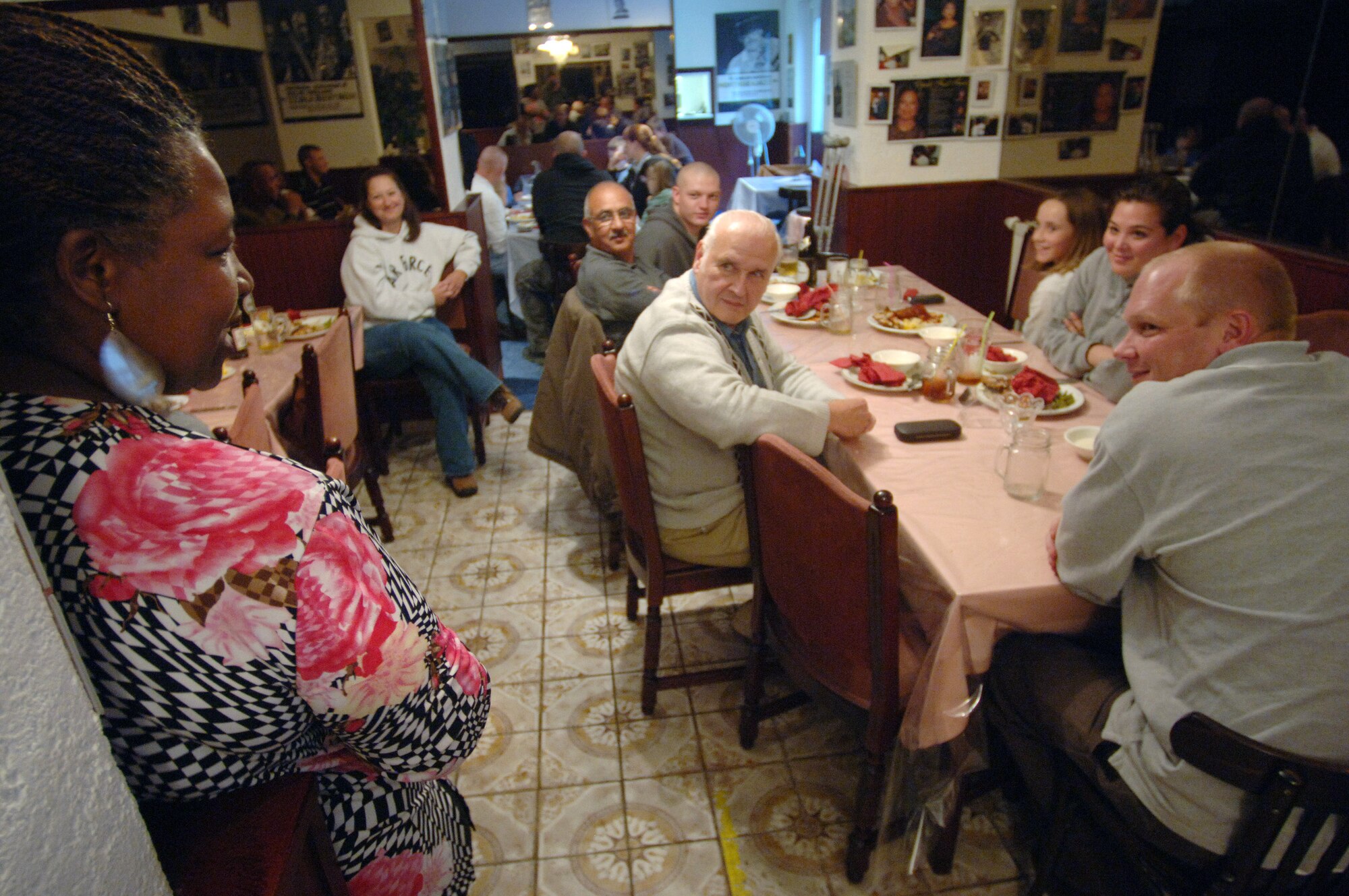 Mama West's restaurant owner Brenda West (left) speaks with wounded service members from Landstuhl Regional Medical Center who, as a house rule, eat for free.  Nearly a half-dozen outpatients from LRMC were transported by "Mission: Just Us" volunteers to the soul-food-style eatery where, as a house rule, they eat for free. Ms. West, an executive chef from Washington D.C. who came to Germany nearly 15 years ago to help raise her grandchildren, opened her restaurant in 1999 with the idea that, as long as she made enough money to pay the bills and feed the soldiers, she would be happy. (U.S. Air Force photo/Master Sgt. Scott Wagers