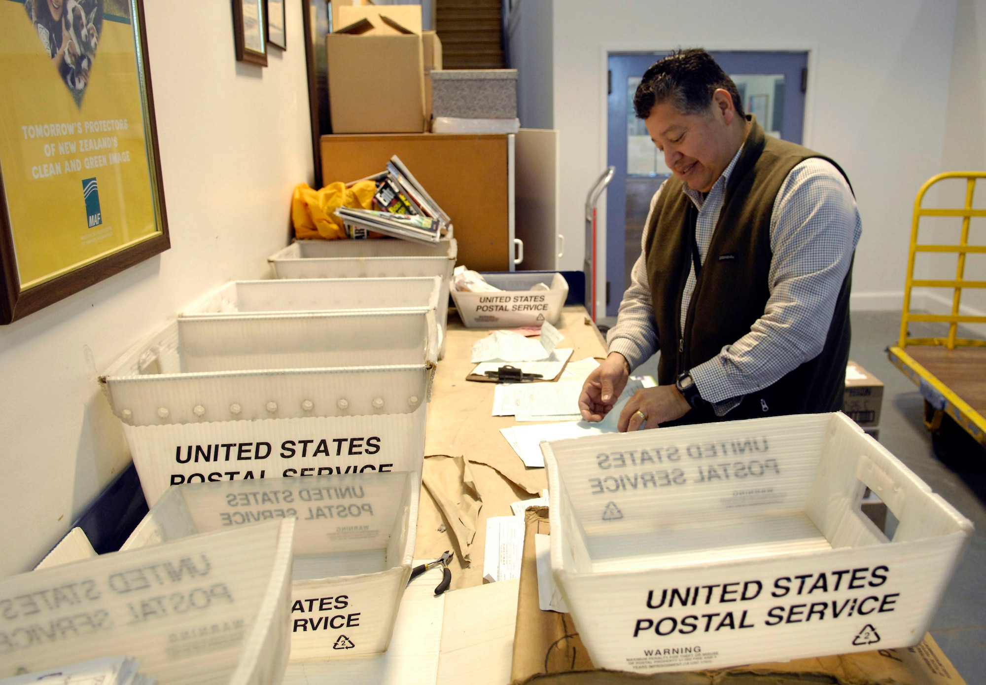 Enrique Garza sorts through incoming mail payment documents for Operation Deep Freeze members Aug. 23 at Christchurch, New Zealand. Members of Det. 4, Pacific Air Forces Air Postal Squadron process all mail coming in and out of Antarctica and can handle up to 240,000 pounds of mail during Operation Deep Freeze. Mr. Garza is a finance and postal clerk. (U.S. Air Force photo/Tech. Sgt. Shane A. Cuomo) 