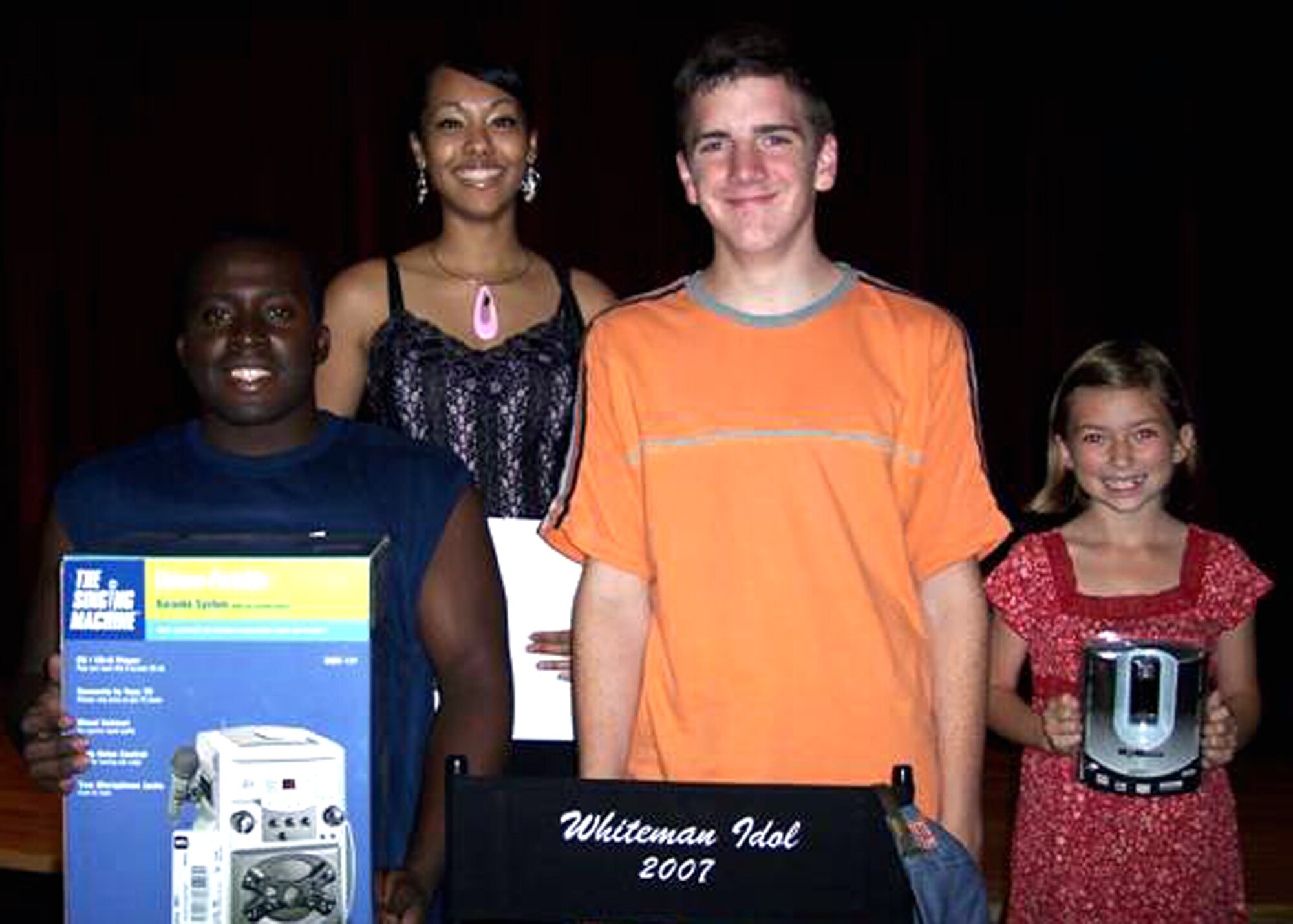 Out of all the singing, comedy and dancing acts the 2007 Whiteman Idol hosted at Community Activities Center Aug. 9, three reigned supreme. The winners of the 2007 Whiteman Idol (left to right) were in 2nd place Airman Eric Prince and Airman 1st Class Cassandra Montgomery, 509th Aircraft Maintenance Squadron, in 1st place Ross Huntington, son of Master Sgt. Bill Huntington, 442nd Fighter Wing and in 3rd place Miriam Hale, daughter of Maj. Timothy Hale, 509th Operations Support Squadron. (Photo by Betty Jones, printed with permission.)