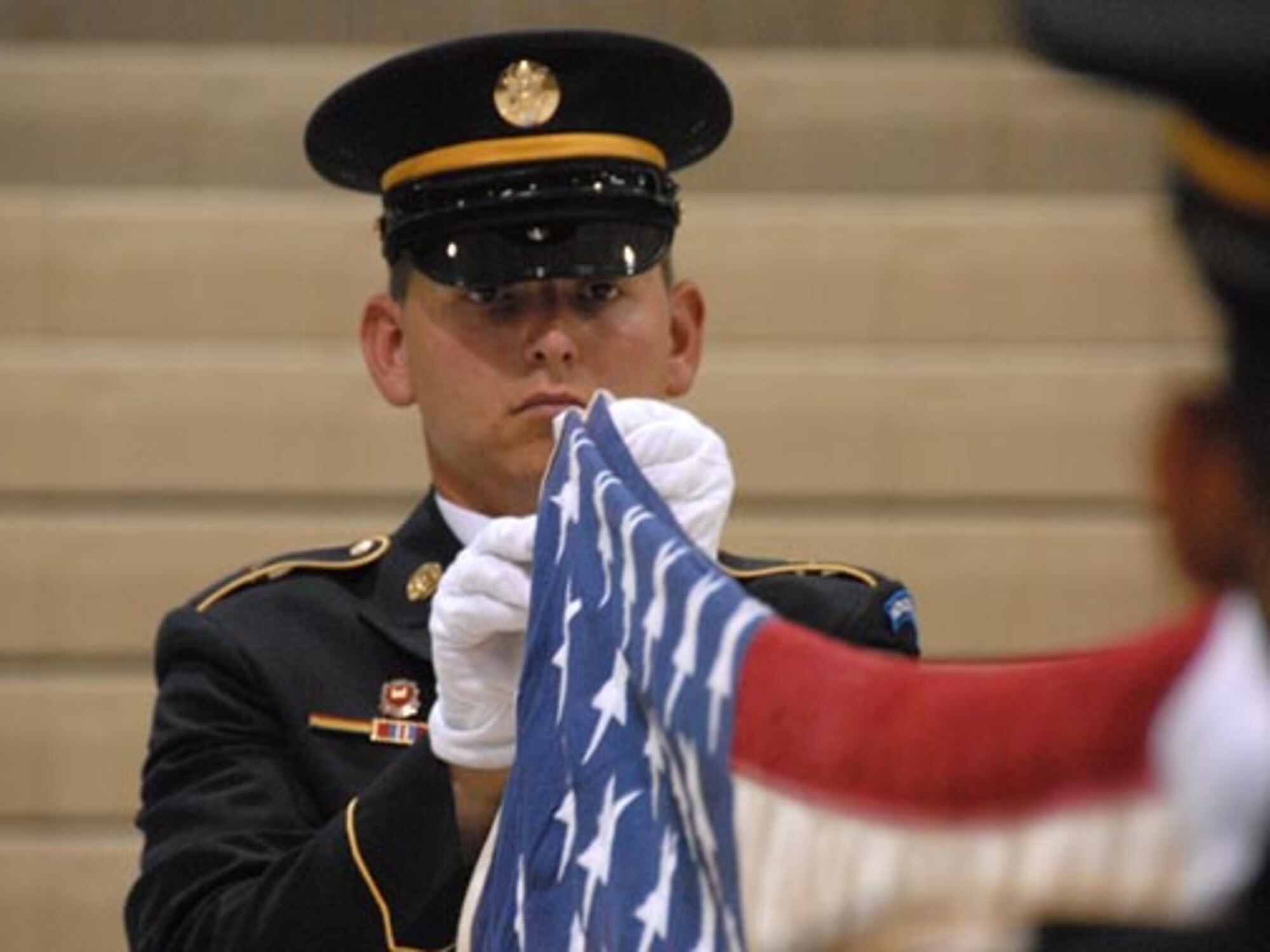 SPC David Saari, North Dakota Army National Guard, folds the United States flag during military funeral honors team training at the Armed Forces Reserve Center, Fargo, N.D., August 17, 2007.  (USAF photo/SMSgt. David Lipp)

