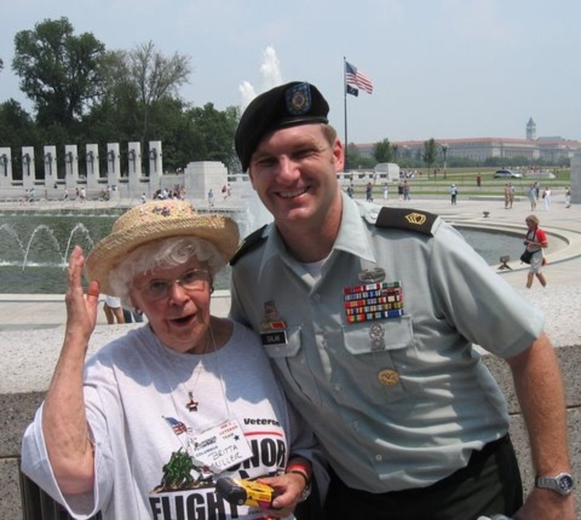 WASHINTONG D.C. -  Former Women’s Army Corps Private First Class Britta L. Miller, a WWII veteran, visits with Army Sergeant First Class Mark Salak at the WWII Memorial in Washington D.C. Sergeant Salak is currently assigned to the Pentagon and regularly meets with veterans coming to the nation’s capital with Honor Flight. (U.S. Air Force photo/Charlie Miller)