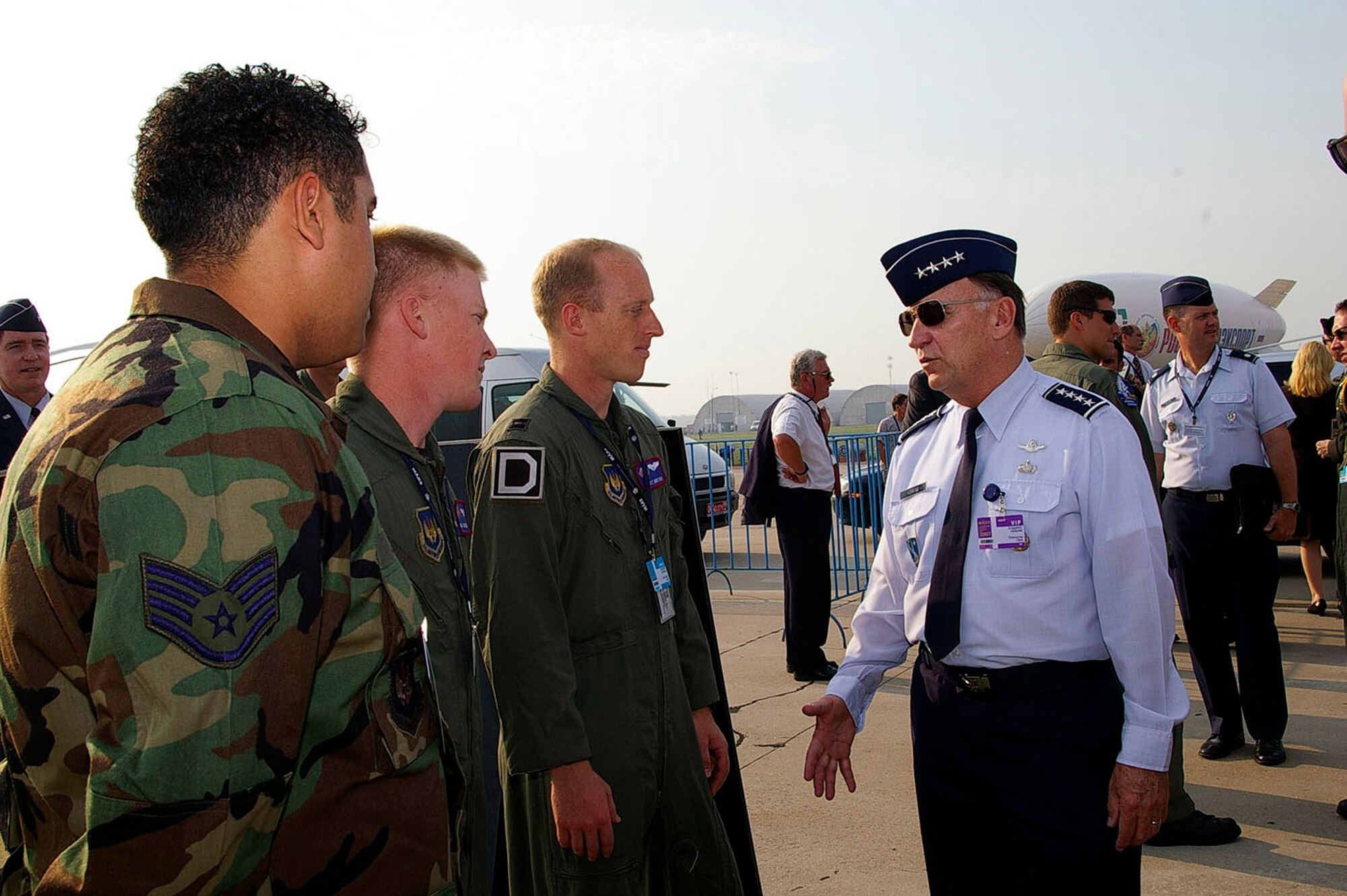 Gen. William T. Hobbins speaks with Staff Sgt. Kevin Jones, Senior Airman Travis Swinson and Capt. Scott Montier during the first day of the Moscow International Air Show Aug. 21 at Ramenskoye Airfield in Zhukovsky, Russia. General Hobbins, commander of U.S. Air Forces in Europe, visited the air show and met with Airmen from his command. The Airmen are from the 100th Air Refueling Wing at Royal Air Force Mildenhall, England. (U.S. Air Force photo/Karen Abeyasekere) 