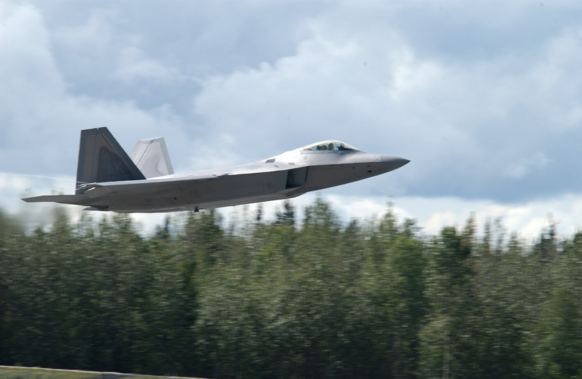 EIELSON AIR FORCE BASE, Alaska --  An F-22 Raptor takes off of the Eielson AFB runway Aug. 22, 2007. The F-22 was on static display during the 354th Fighter Wing change of command ceremony, and left soon after the ceremony was over.  (U.S. Air Force photo by Airman 1st Class Christopher Griffin)