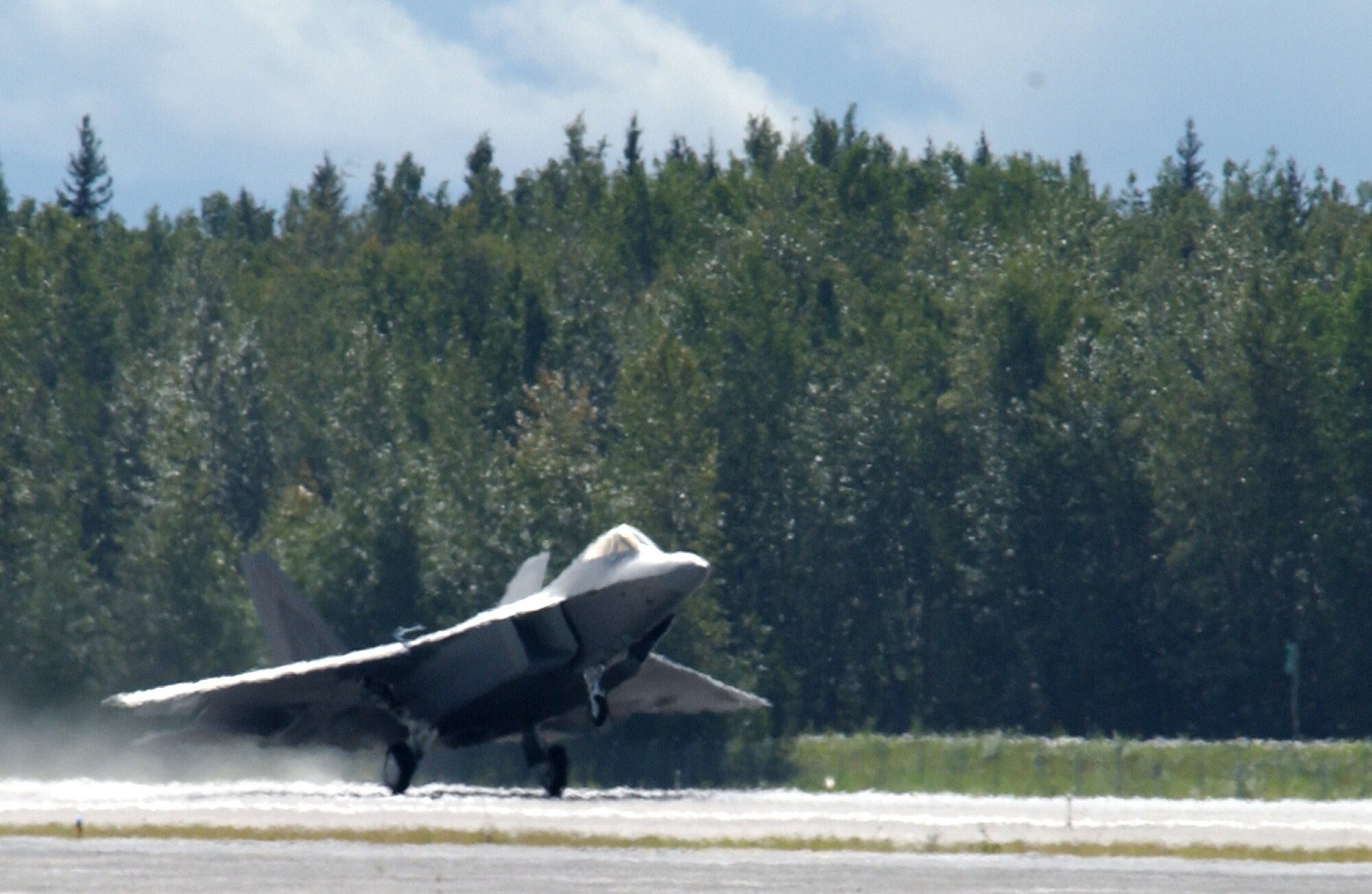 EIELSON AIR FORCE BASE, Alaska --  An F-22 Raptor takes off of the Eielson AFB runway Aug. 22, 2007. The F-22 was on static display during the 354th Fighter Wing change of command ceremony, and left soon after the ceremony was over.  (U.S. Air Force photo by Airman 1st Class Christopher Griffin)