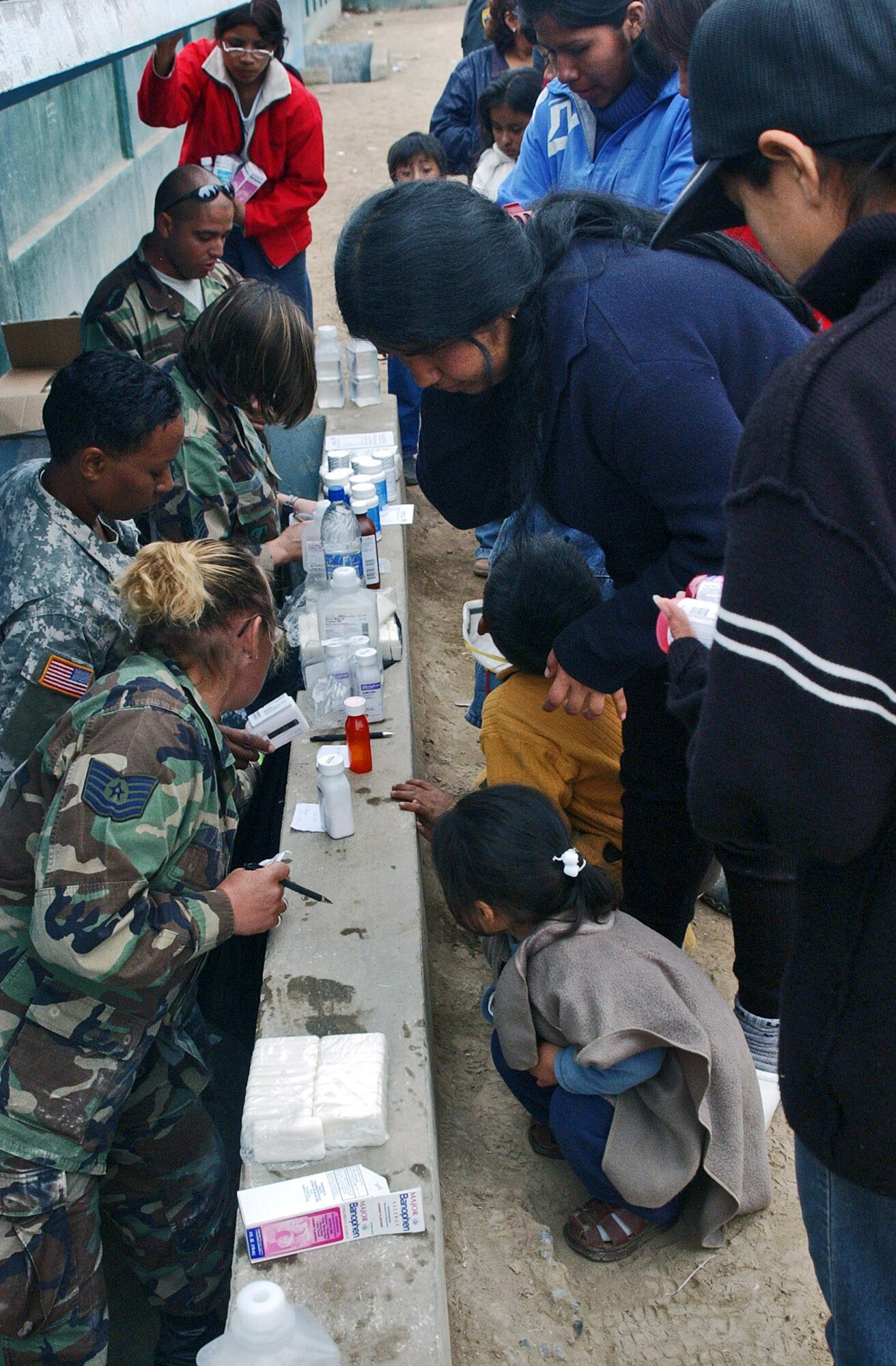 Patients line up as members of Joint Task Force-Bravo's medical humanitarian relief task force hand out prescribed medicines Aug. 21 in Pisco, Peru. The team saw more than 1,500 patients in three days, diagnosing ailments such as gastro-intestinal illness and respiratory infections. The humanitarian relief task force was sent to Pisco following the 8.0 magnitude earthquake that struck the region Aug. 15. (U.S. Air Force photo/Senior Airman Shaun Emery) 
