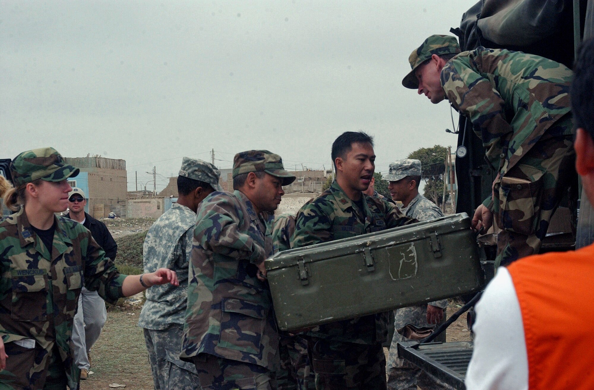 Capt. Sanjoy Malhotra, Maj. Paul Valdez and Capt. William Ingram unload medical supplies Aug. 21 in Pisco, Peru. The citizens of Pisco were provided basic medicines and medical care following the 8.0 magnitude earthquake that devastated the town Aug. 15. The officers are from Joint Task Force Bravo's medical humanitarian relief task force. JTF-Bravo members treated more than 1,500 in three days. (U.S. Air Force photo/Senior Airman Shaun Emery) 
