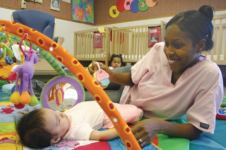 Provider Delvia Billings plays with Audrey Gonzales in the infant room. Katmai provides daily care to nearly 200 children, ages 6-weeks through 5-years-old. (U.S. Air Force photo by Staff Sgt. Olenda Peña Perez)