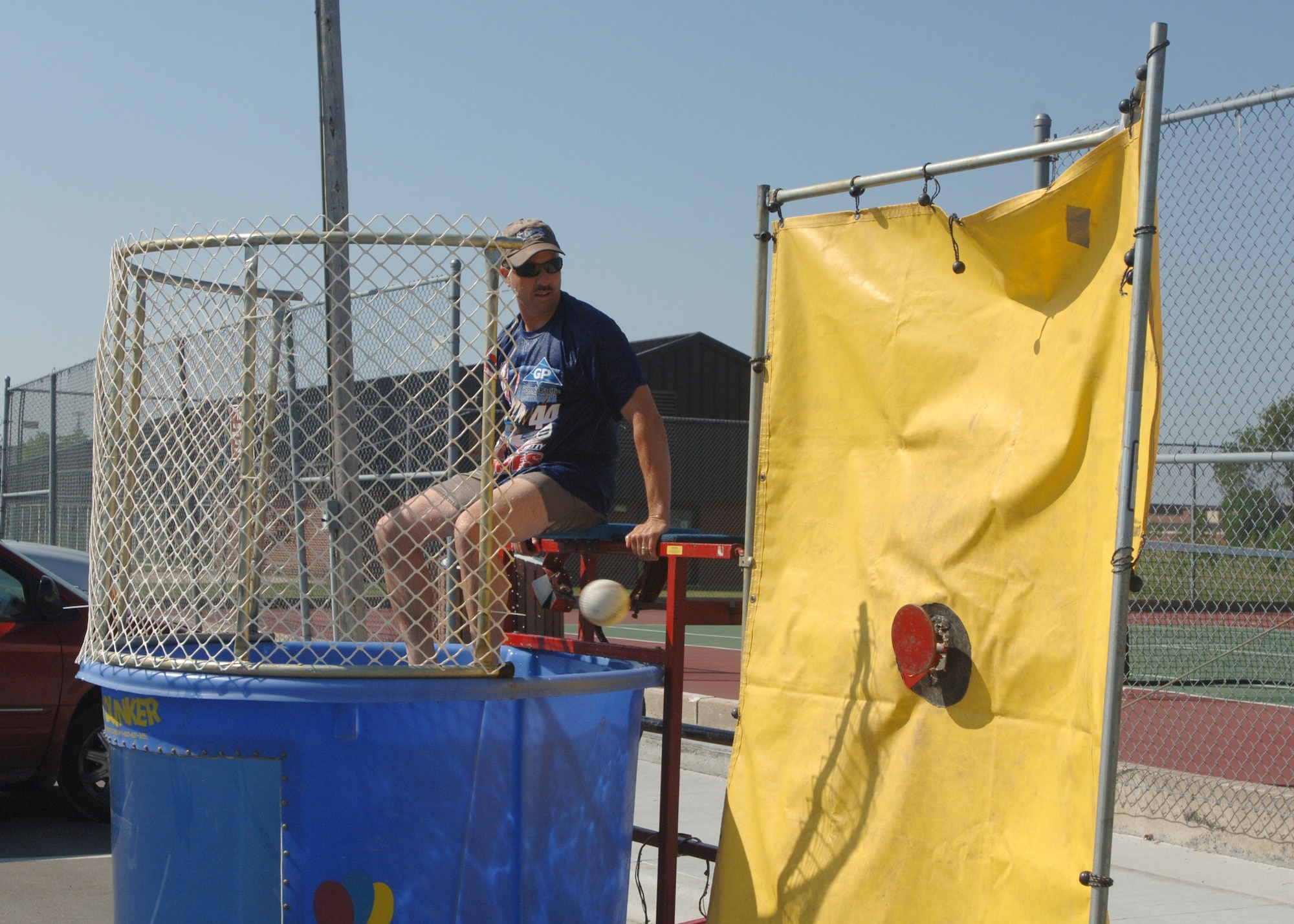 Chief Master Sgt. Jon Saiers, 319th Air Refueling Wing command chief, watches closely as a softball zeros in on its target, sending the chief into the vat of chilly water. Chief Saiers was one of many chiefs, as well as the wing commander and wing vice commander, that offered to take the plunge. The chief’s dunk tank occurred Aug. 15 to support the upcoming Air Force Ball. (U.S. Air Force photo/Airman 1st Class Chad Kellum)
