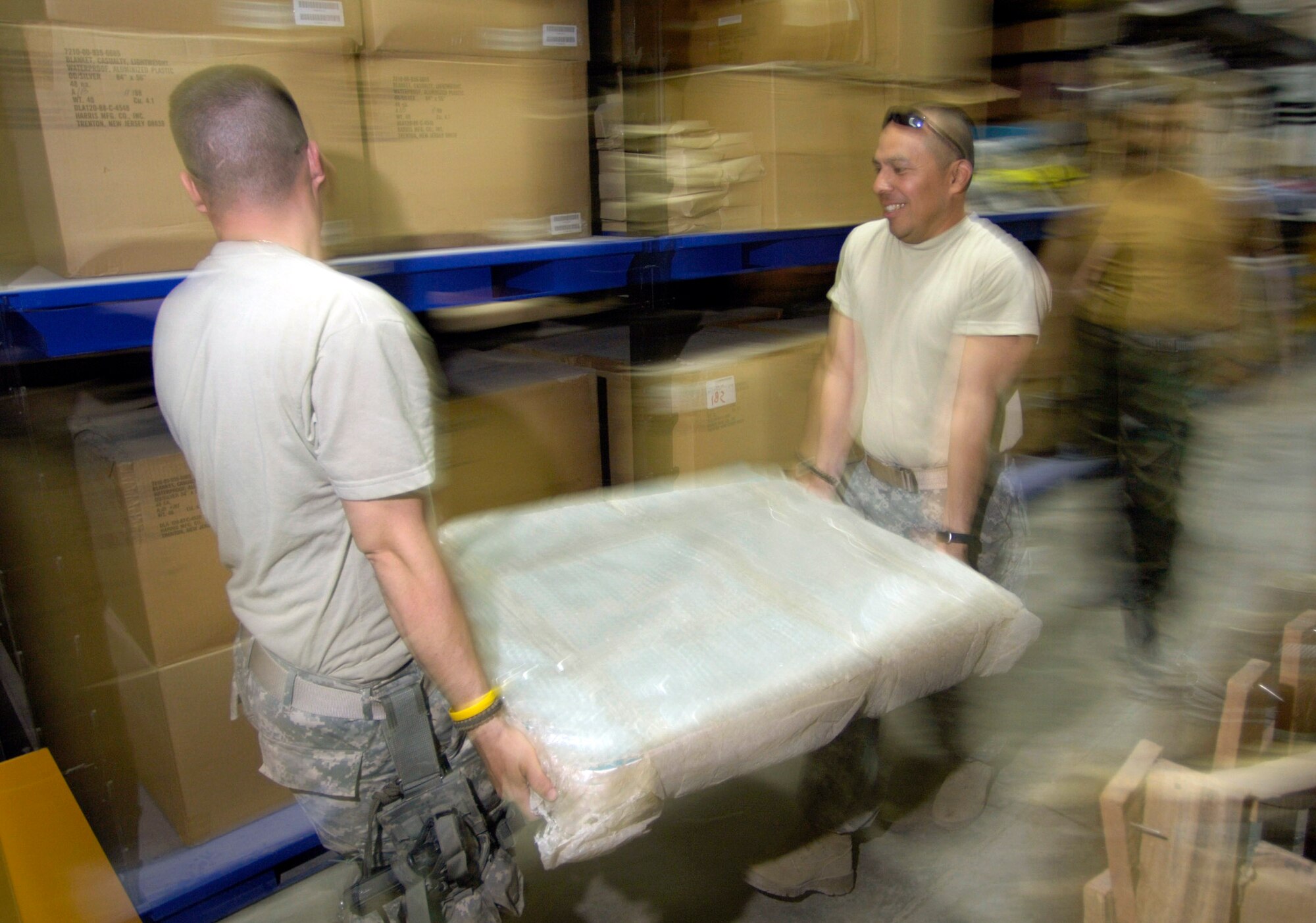 Master Sgt. Doug Suddueth (left) and Army Sgt. 1st Class Antonio Rivas carry a load of medical equipment to a truck Aug. 17 in Afghanistan. The medical equipment is being transported to a new $6.5 million, 50-bed hospital on the Afghan national army's Hero Camp near Kandahar Airfield in southern Afghanistan. Sergeant Suddueth is deployed from Maxwell Air Force Base, Ala. Sergeant Rivas is deployed form Fort Sam Houston, Texas. They are medical logistics craftsmen and Afghan national army mentors assigned to the Combined Security Transition Command-Afghanistan on Camp Eggers in Kabul, Afghanistan. (U.S. Air Force photo/Master Sgt. Jim Varhegyi)