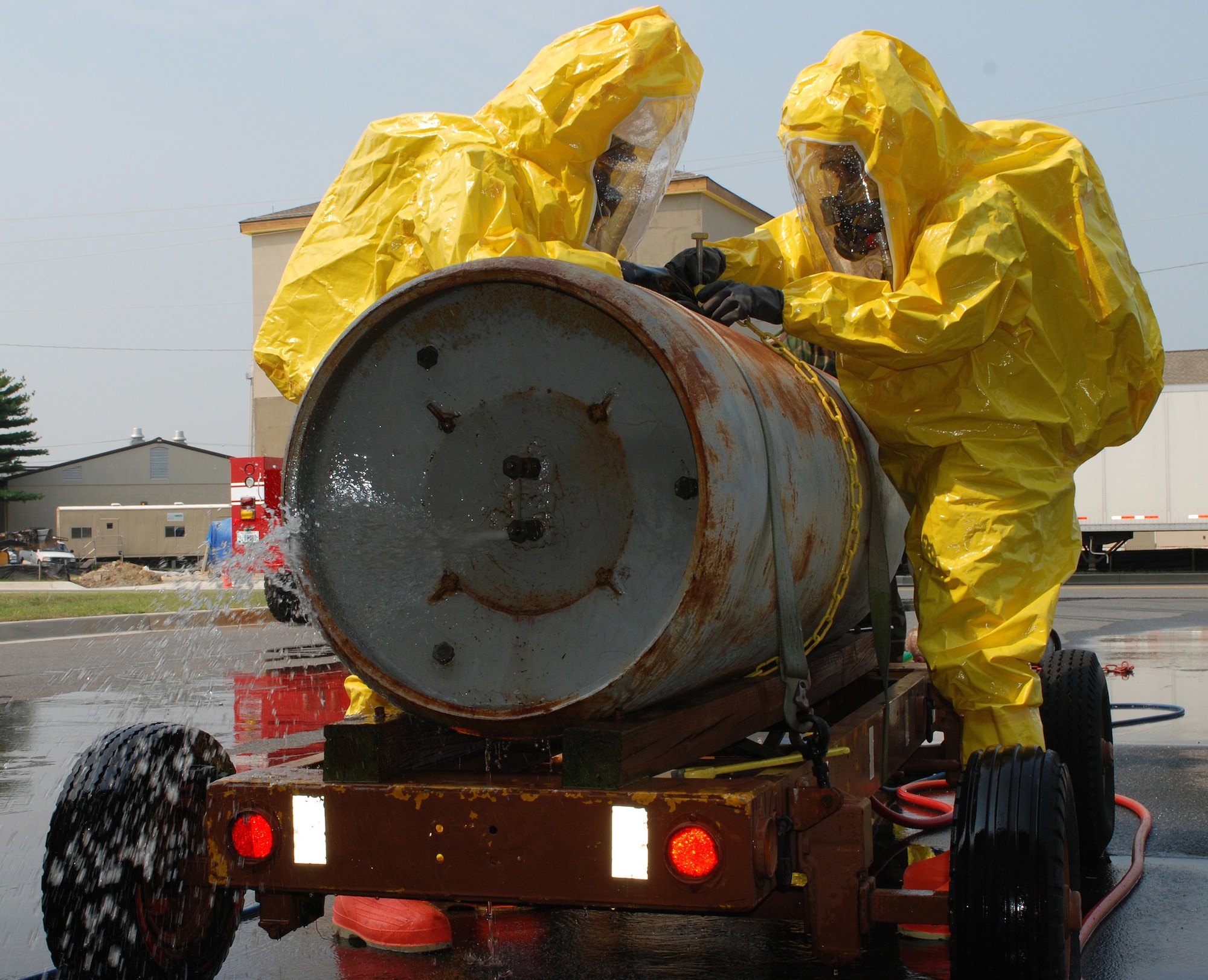 DOVER AIR FORCE BASE, Del. -- 512th Civil Engineer Squadron firefighter, Airman 1st Class Bryant Dawson, and 436th CES firefighter Staff Sgt. Leonard Smallwood fix a leak on a simulated corrosive cylinder during hazardous material handling training.  The training was held Aug. 17 for both the Reserve and active-duty squadrons. (U.S. Air Force photo/Staff Sgt. Steve Lewis)