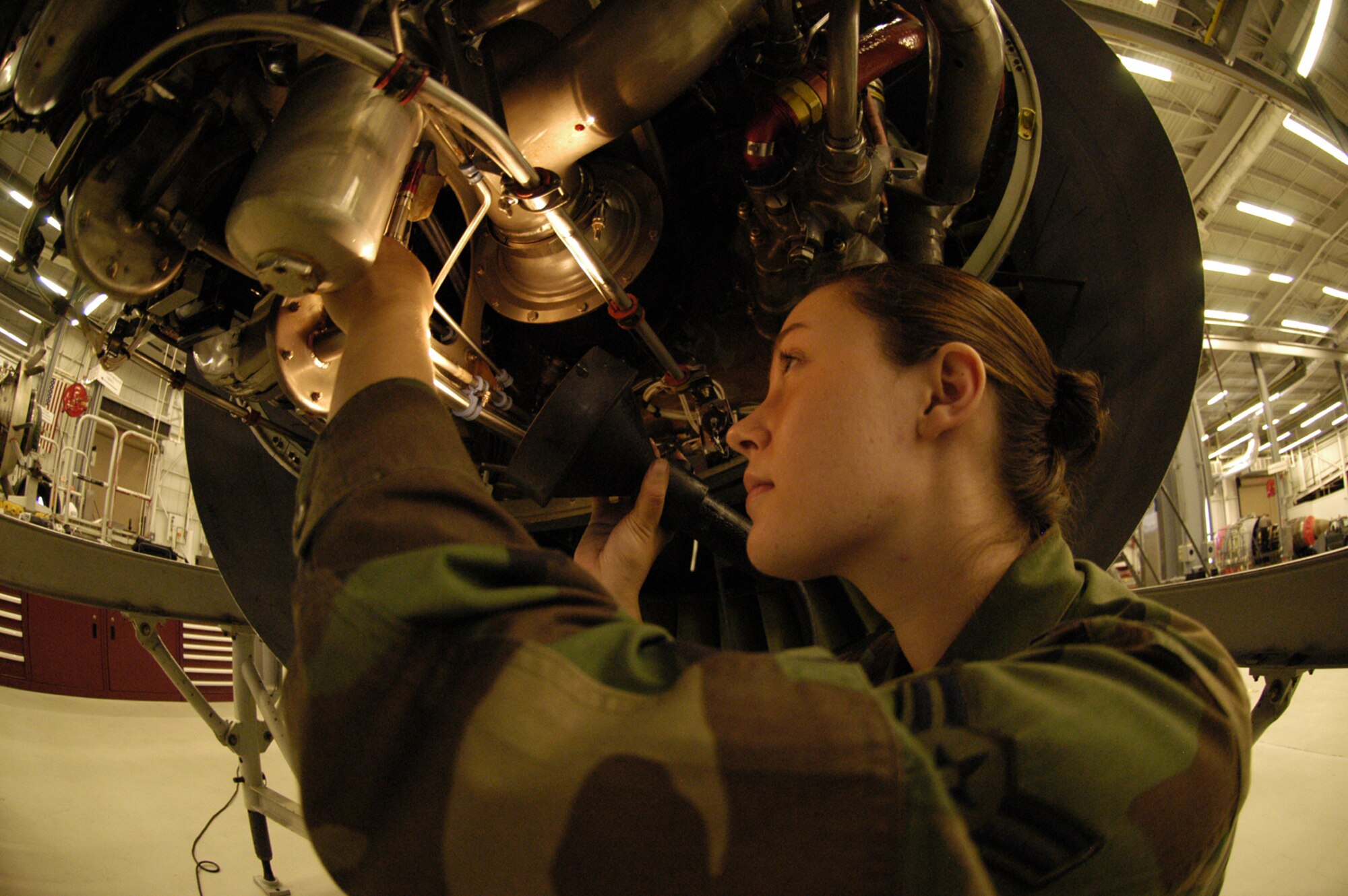 Airman 1st Class Rebecca Summerville, 436th Maintenance Squadron propulsion apprentice, inspects an engine. She looks for loose bolts or safety wires and ensures everything is tightened and clamped, there are no leaks and everything functions properly. (U.S. Air Force photo/Airman Shen-Chia Chu)