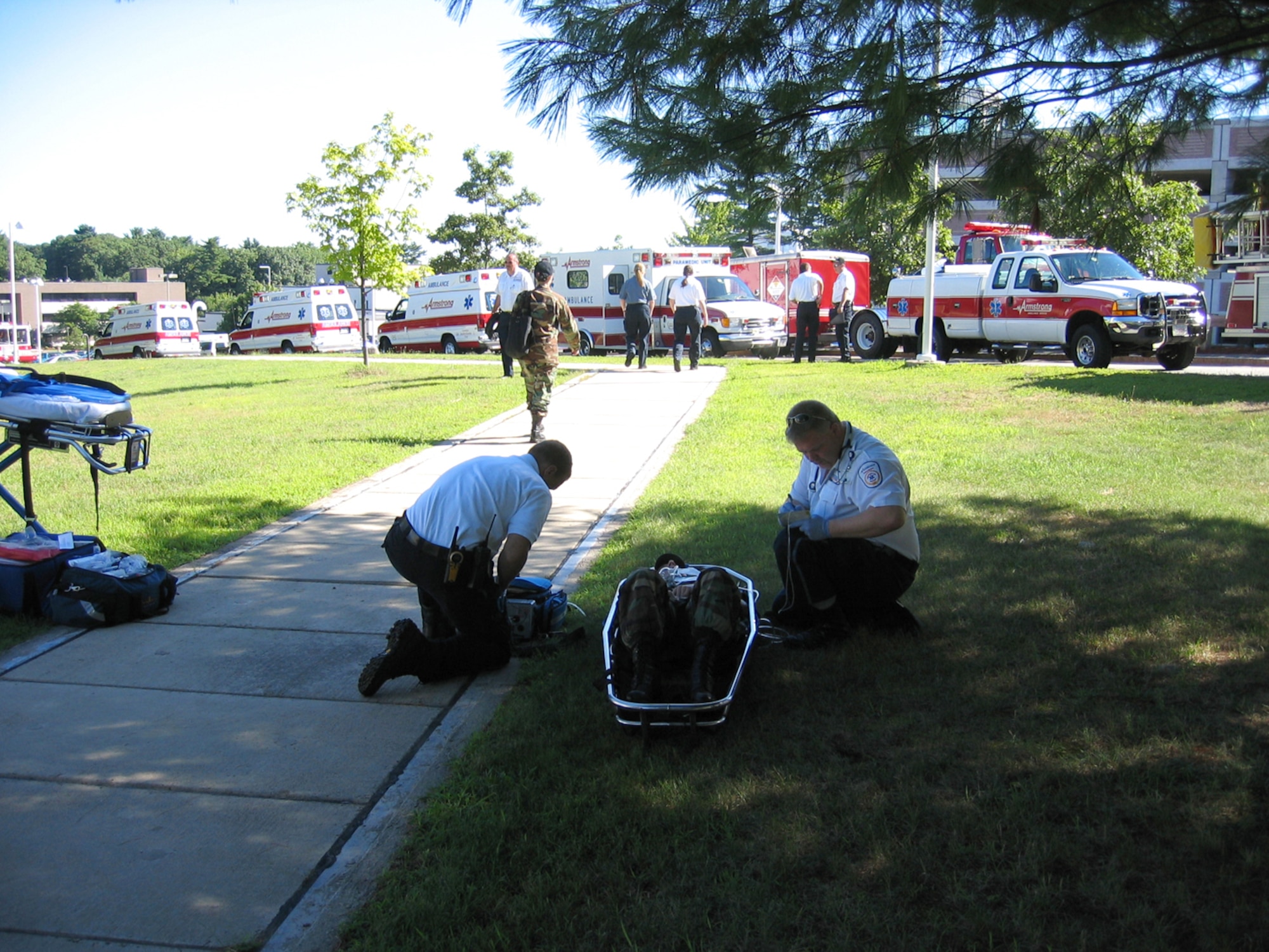 Emergency Management personnel respond to the scene of a simulated hazardous material and mass casualty incident during the Base Readiness Exercise held here Aug. 14. During the exercise, the Electronic Systems Center Inspector General's Office tested the base's ability to recall and operate the Emergency Operations center, a body formed under the Air Force Incident Management System, which will be implemented Air Force-wide by December 2007. (U.S. Air Force photo by Senior Airman Brian Whittemore.)
