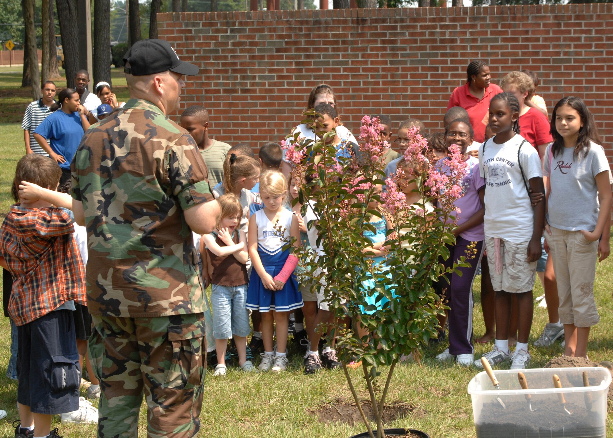 SEYMOUR JOHNSON AIR FORCE BASE, N.C. - Lieutenant Colonel Anthony Higdon, 4th Civil Engineering Squadron commander, speaks to youth center environmentalists about the importance of planting trees and taking care of them on August 15. The tree planting is part of Arbor day held on base.(US Air Force photo by Airman First Class Ciara Wymbs
 