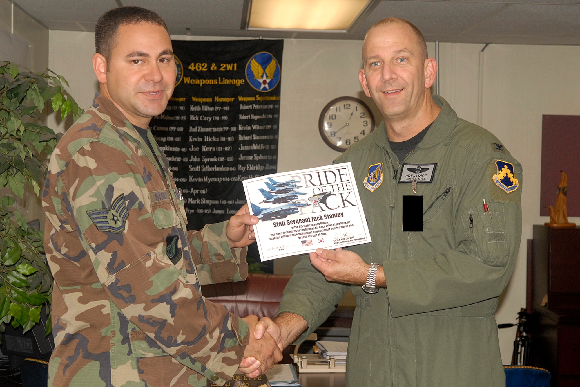KUNSAN AIR BASE, South Korea -- Colonel Creig "Wolf 2" Rice, 8th Fighter Wing vice commander, awards Staff Sgt. Jack Stanley, 8th Maintenance Group weapons loader, the Pride of the Pack certificate here Aug. 16. Sergeant Stanley was recognized as the 8th FW's Pride of the Pack for the week of Aug. 13. (U.S. Air Force photo/Senior Airman Giang Nguyen) 