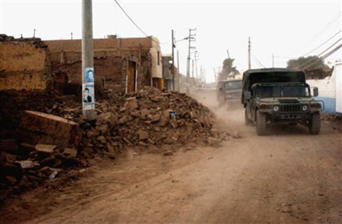 Personnel from Joint Task Force-Bravo's medical humanitarian relief task force make their way through the streets of Pisco, Peru, Aug. 21. The task force treated more than 1,500 people during their deployment to Peru, following the 8.0 magnitude earthquake that struck the region, Aug. 15. 