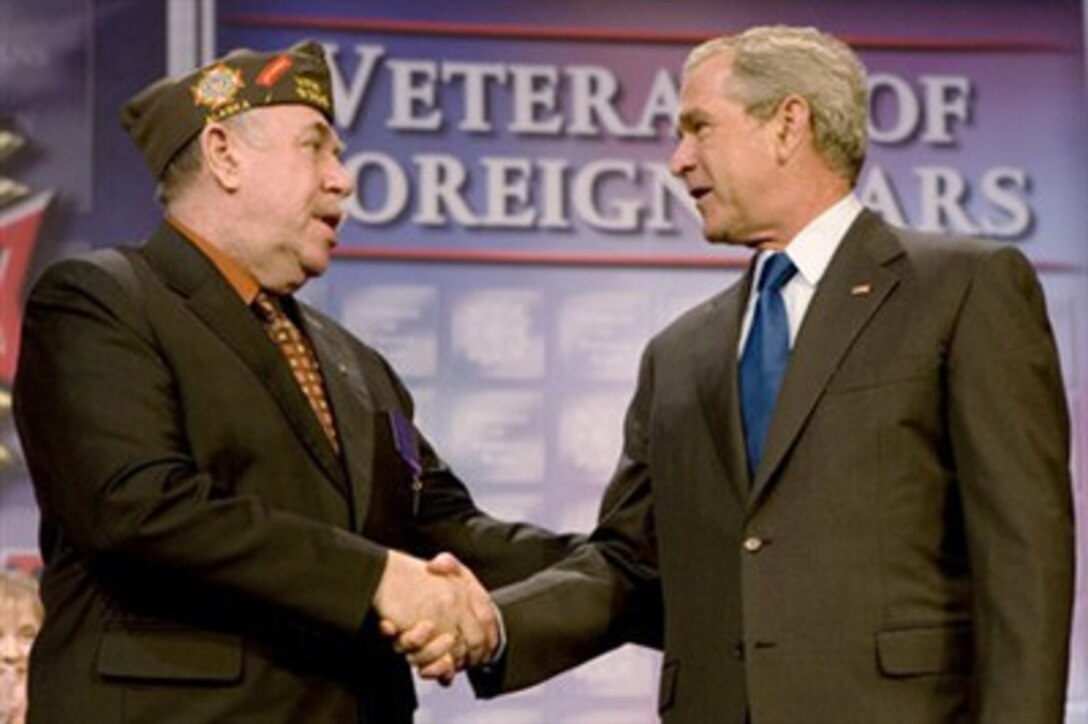 President George W. Bush shakes hands with Veterans of Foreign Wars National Commander Gary Kurpius following the president's address, Aug. 22, 2007, to the Veterans of Foreign Wars National Convention in Kansas City, Mo. 