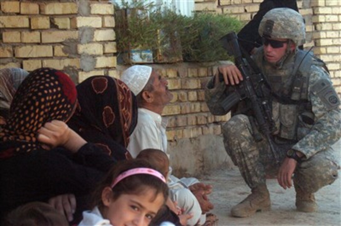 U.S. Army 1st Lt. Brandon Whitis speaks with a local man about conditions in the Diyala River Valley region of Iraq on Aug. 16, 2007.  Whitis and his fellow soldiers from Bravo Company, 1st Battalion, 505th Parachute Infantry Regiment, 82nd Airborne Division are patrolling in the region looking for insurgents and weapons caches.  