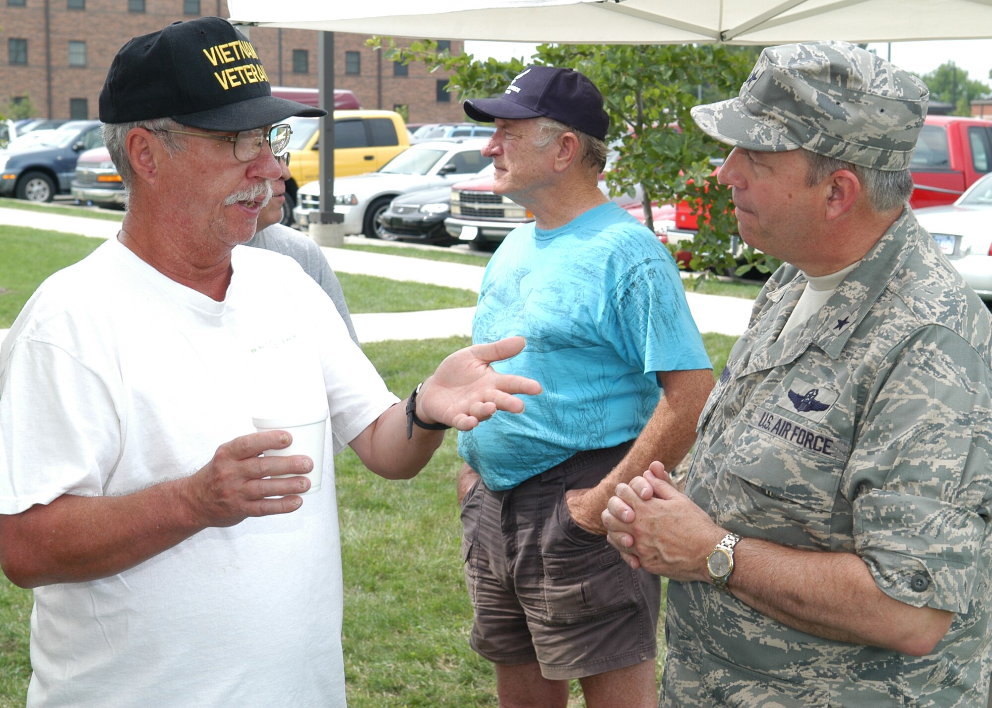 GRISSOM AIR RESERVE BASE, Ind., -- Brig. Gen. Dean Despinoy, 434th Air Refueling Wing commander, right, listens to a retiree during Grissom's retiree appreciation day held Aug. 24. Military retirees from all branches visited the base to participate in an information fair and have lunch. (U.S. Air Force photo/Senior Airman Chris Bolen)
